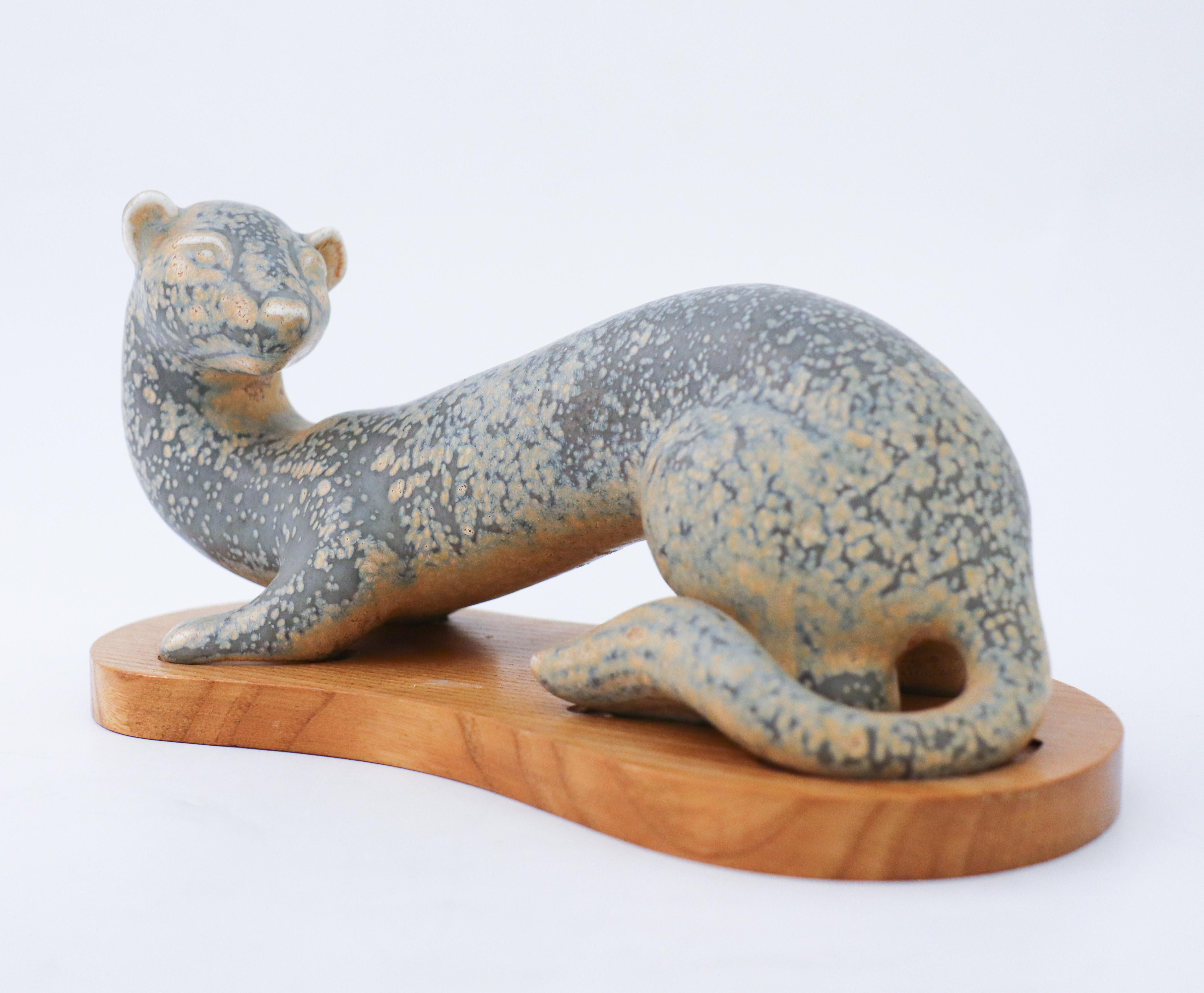 A figurine of a Ferret designed by Gunnar Nylund at Rörstrand, it is 12 cm high and in very good condition with a lovely glaze. It is marked as 1st quality.