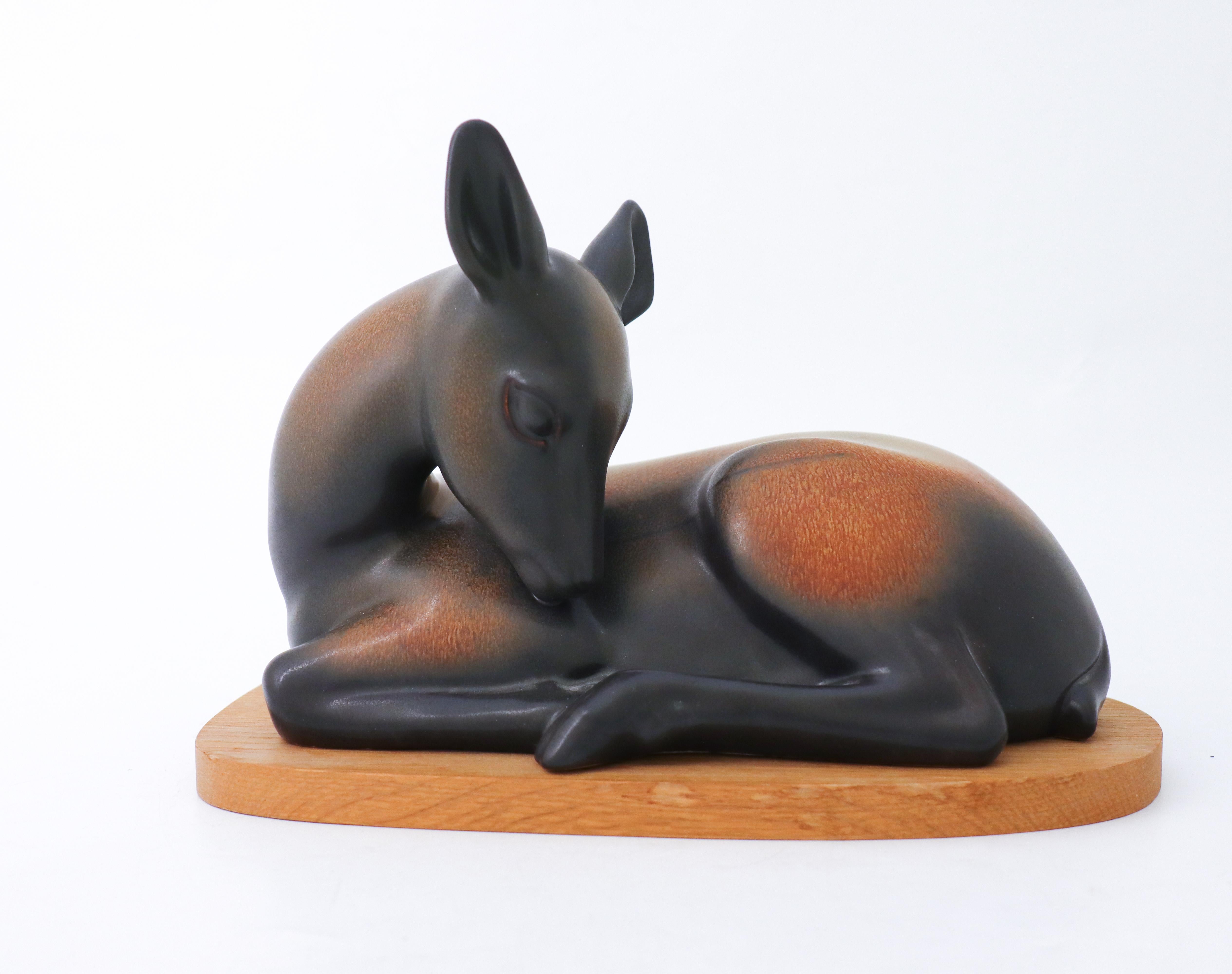 A sculpture of a deer in ceramic designed by Gunnar Nylund at Rörstrand. It is 27,5 x 16.5 cm (11