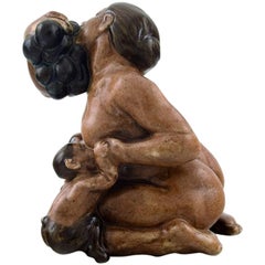 Ceramic Figurine of a Kneeling Woman with Fauns and a Bunch of Grapes