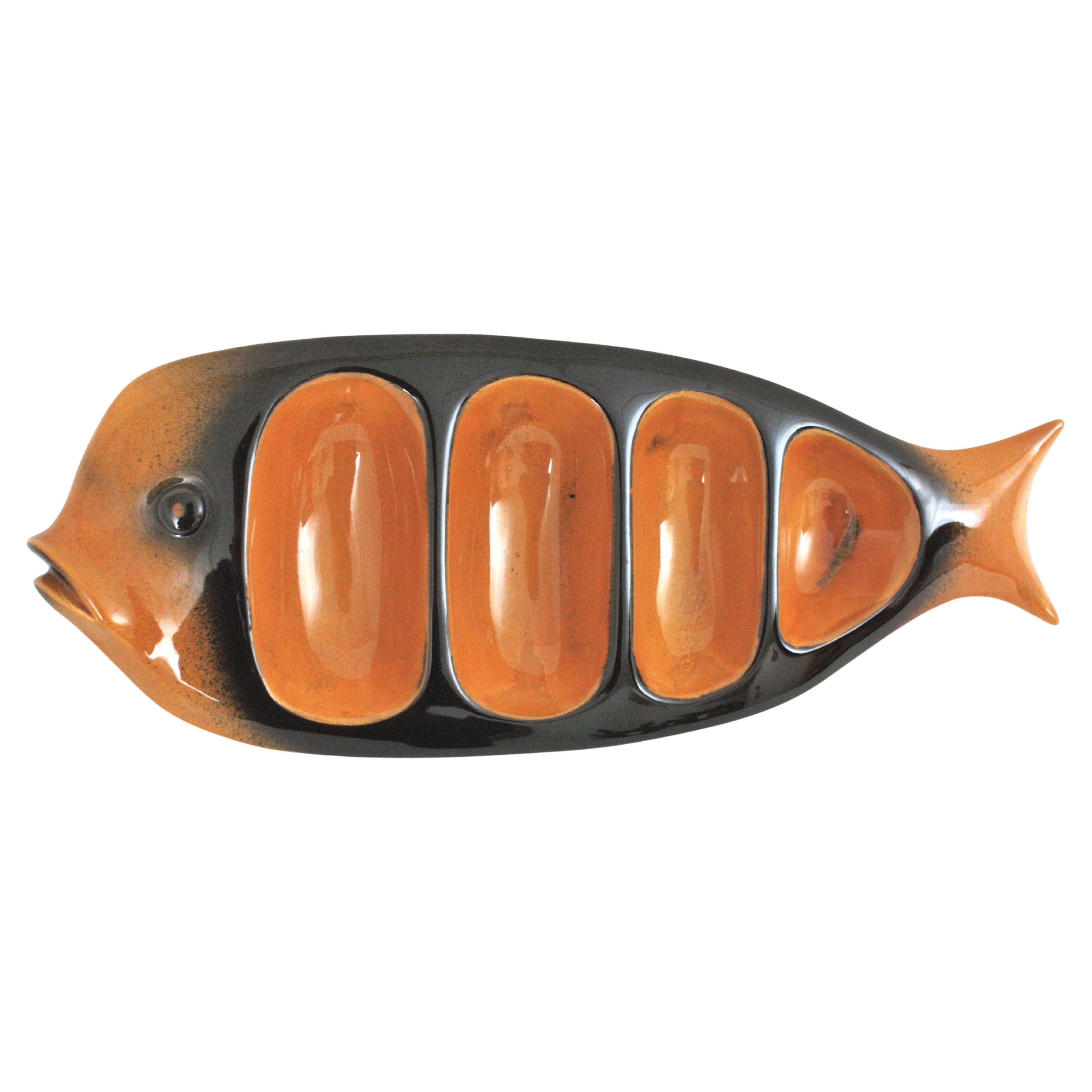 Gran fuente/plato de pared de pescado en cerámica esmaltada ámbar y negra, España, años 50.
La pieza de servicio perfecta para el ocio o la fiesta, con cuatro compartimentos.
Se puede colgar en la pared con más platos o fuentes de pescado de