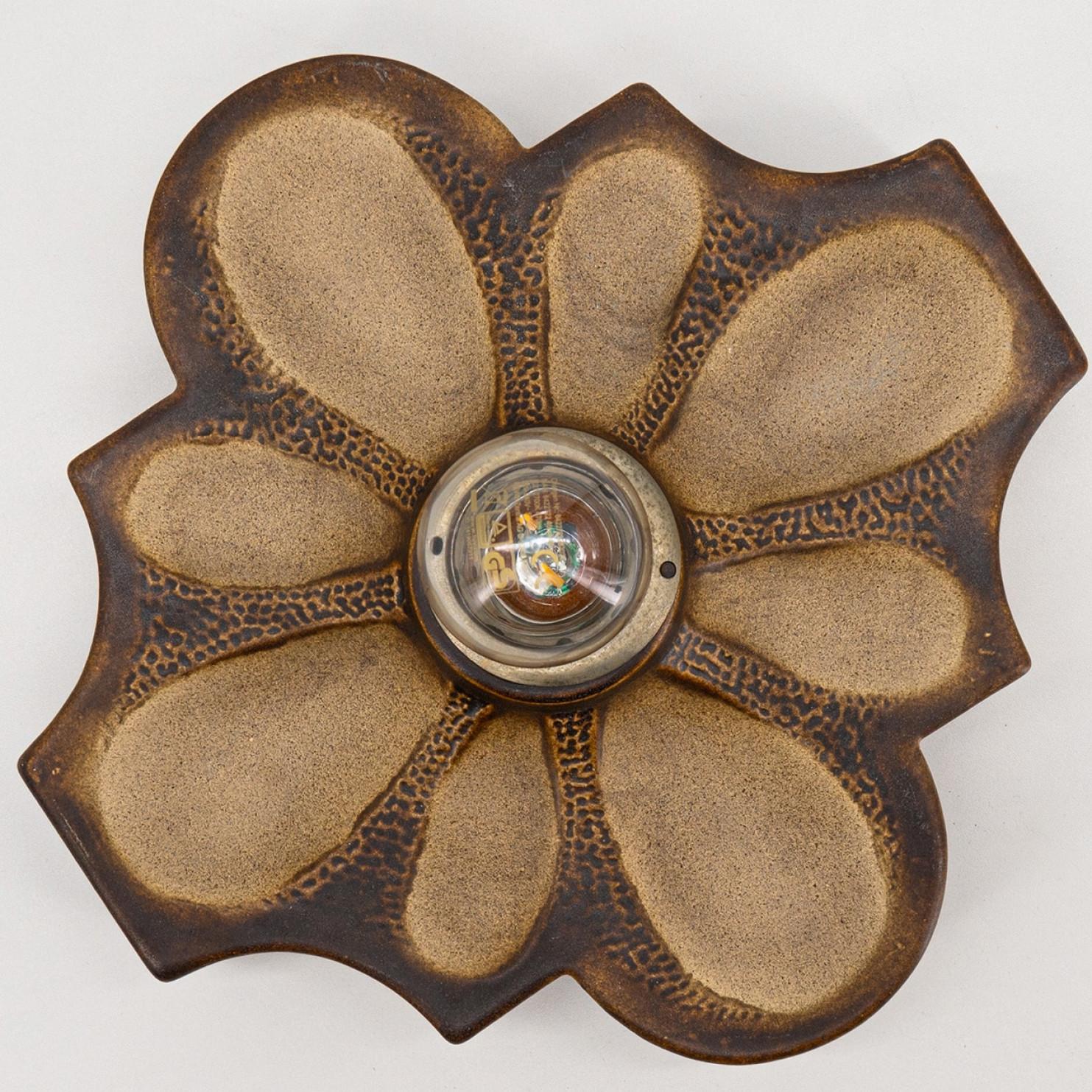 Ceramic wall flower light in Fat Lava style. Manufactured by Pan Leuchten, Germany in the 1960s.

The style of the glaze is called 'Fat Lava'. Which means the glaze is thick on some parts, like lava.
A typical way to finish ceramic in mid-century