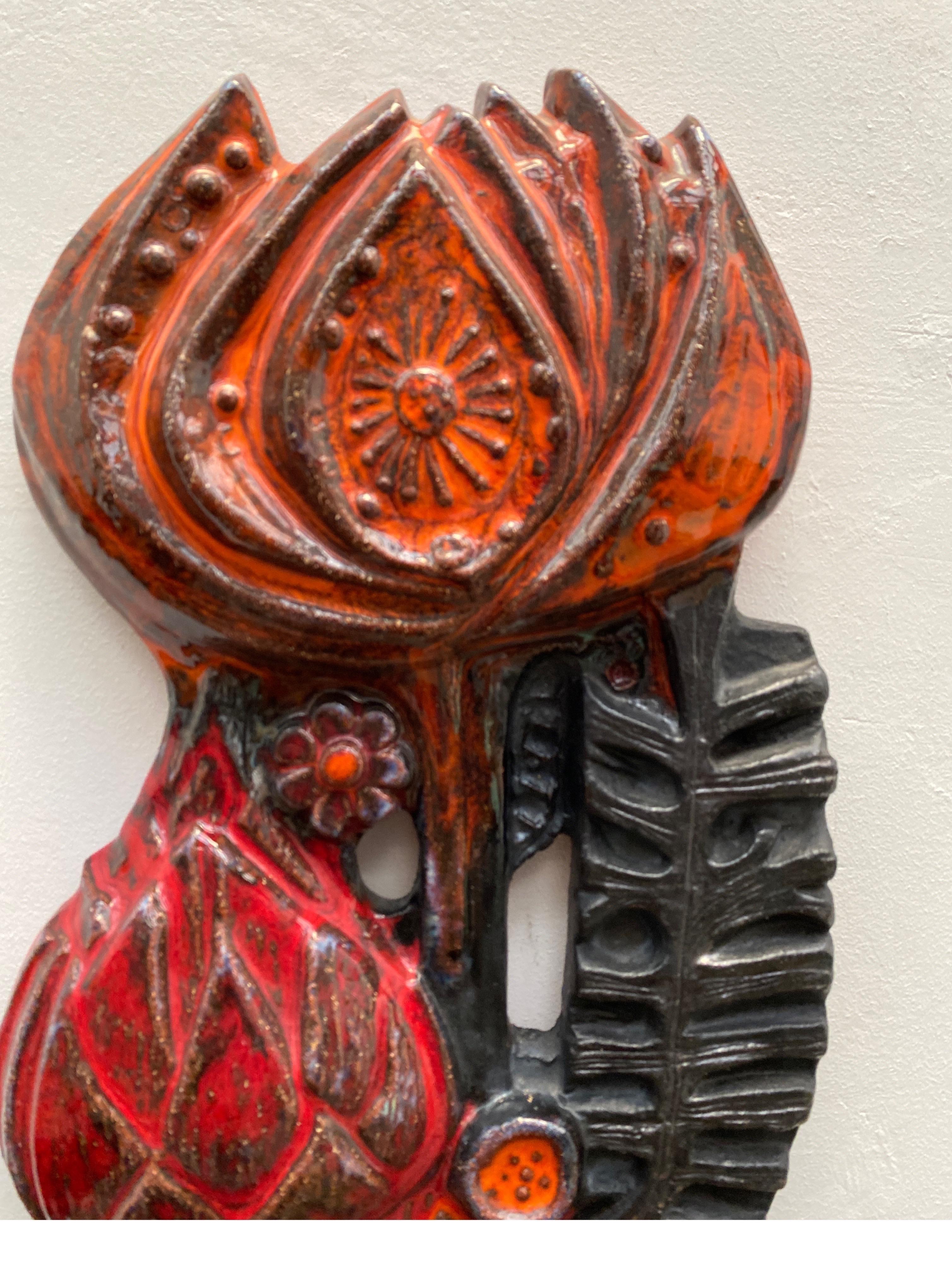 Beautiful abstracted flower wall sculpture was a cooperation between Perignem and Paul Vermeire a decorative ceramic wall sculpture with colors in deep red, black and orange glaze. The sculpture is in perfect condition. It is not marked.