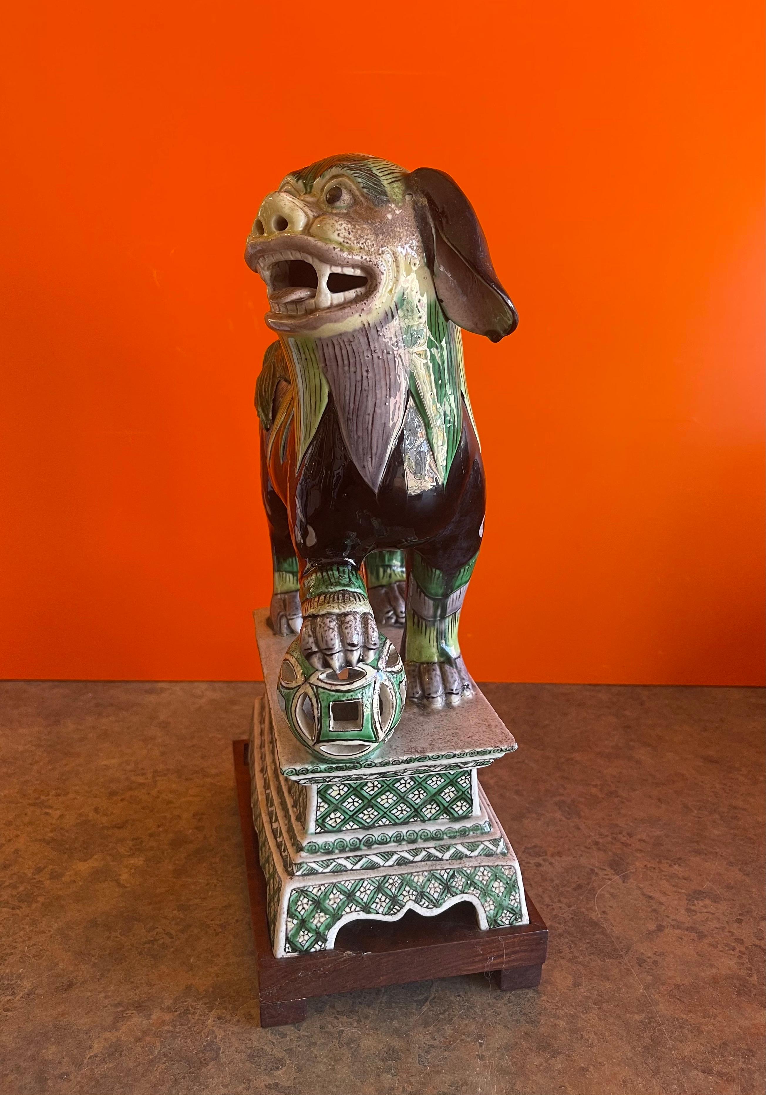 Chinese Ceramic Foo Dog Sculpture on Mahogany Base For Sale