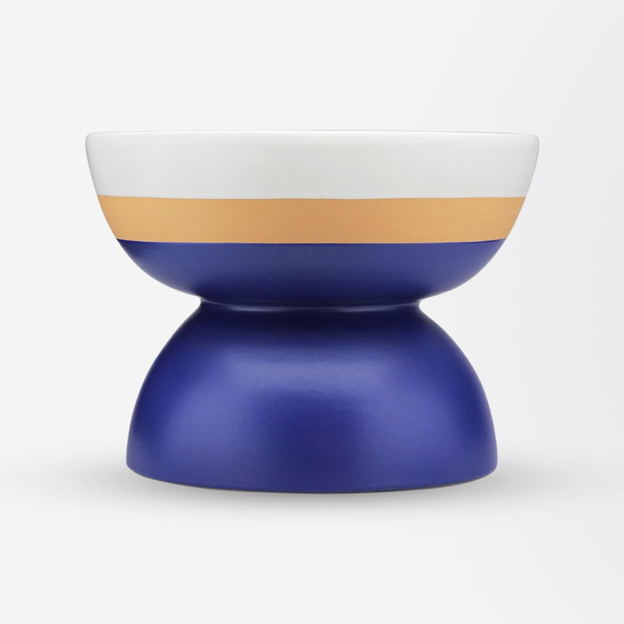 A modern made hand turned red clay bowl by Bitossi of Italy in a design by Ettore Sottsass (1917-2007). The hand crafted piece has been finished in a two tone matte white and indigo blue glaze and has been signed to the underside 'E.Sottsass