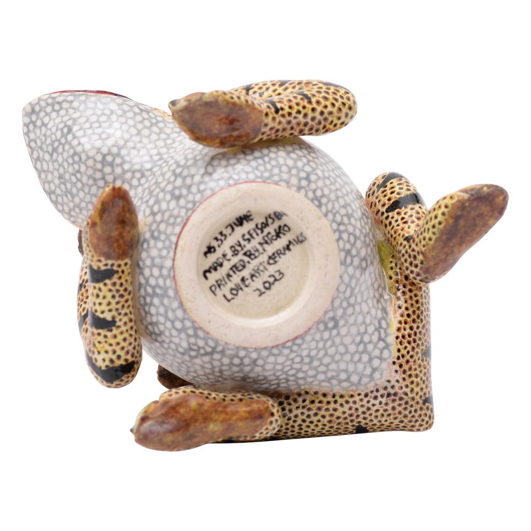 This ceramic frog-shaped container, a unique creation from the hands of South African artisans, is a charming blend of whimsy and craftsmanship. Lovingly handcrafted, its playful frog shape exudes character and charm, making it a delightful addition