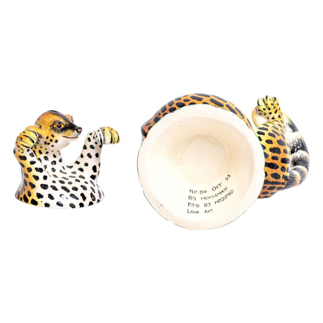 Crafted by the skilled hands of South African artisans, this ceramic Genet cat jewelry box is a masterpiece of traditional craftsmanship and contemporary design. Standing at 6 inches high, with a length of 5 inches and a width of 3 inches, it's a