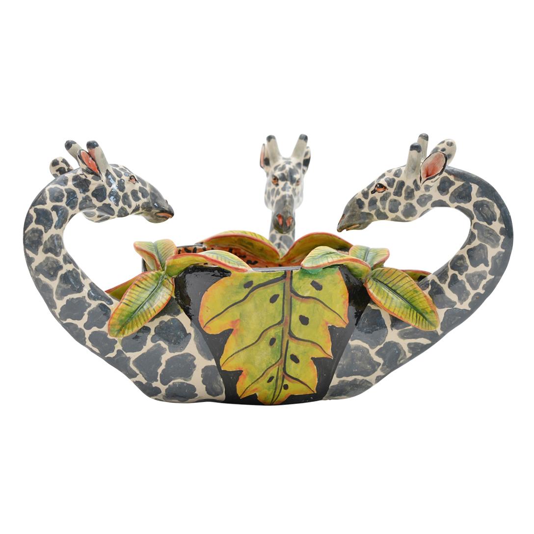 Introducing a delightful ceramic Giraffe peanut bowl, a masterpiece crafted by the talented Palesa and hand-sculpted by Teboho Ndlovu at Imvelo Natural Art in South Africa. Measuring 5 inches high, 9 inches in length, and 5 inches wide, this bowl is