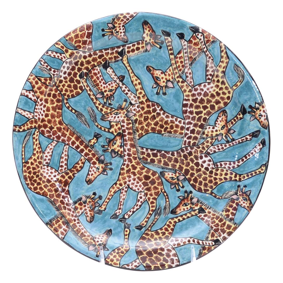 Introducing the exquisite Giraffe Plate, a stunning hand-painted ceramic masterpiece by renowned artist Nompilo Zaba and hand-sculpted by Victor Shabalala, created in the heart of South Africa's Zimele Ceramics studio. This exceptional piece