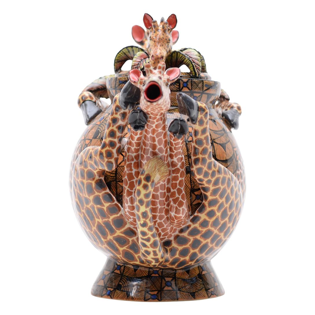 Giraffe Teapot: Hand-Painted by Winnie and Sculpted by Sfiso

The Giraffe Teapot is a delightful fusion of functionality and artistry, crafted by Love Art Ceramic in South Africa in 2024. This enchanting piece measures 8 inches high, 12 inches long,