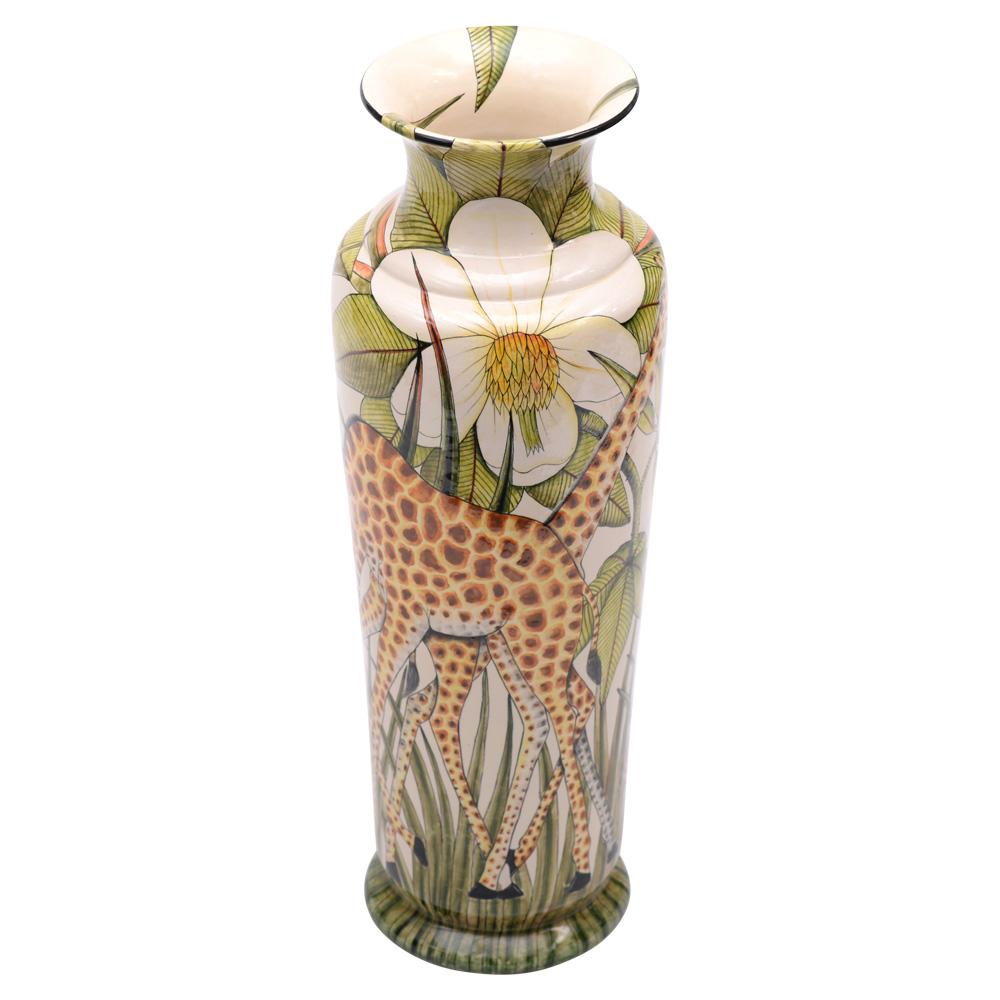 Hand-sculpted by George Mnyathela and hand-painted by Wiseman Ndlovu at Wiseman Ceramics in South Africa, this ceramic Giraffe vase stands 24 inches high, with dimensions of 8 inches in both length and width. Designed by Wiseman Ndlovu, the vase