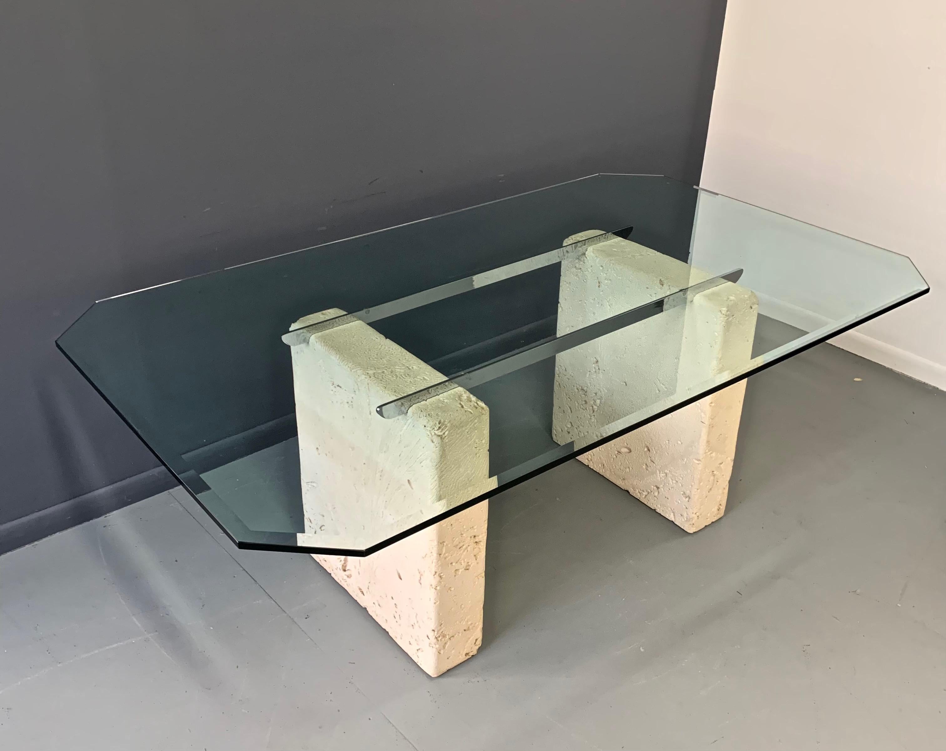 This incredible dining table has two pedestals that are ceramic and have been impressed with a brain coral design and are then held in place by two chrome bars.