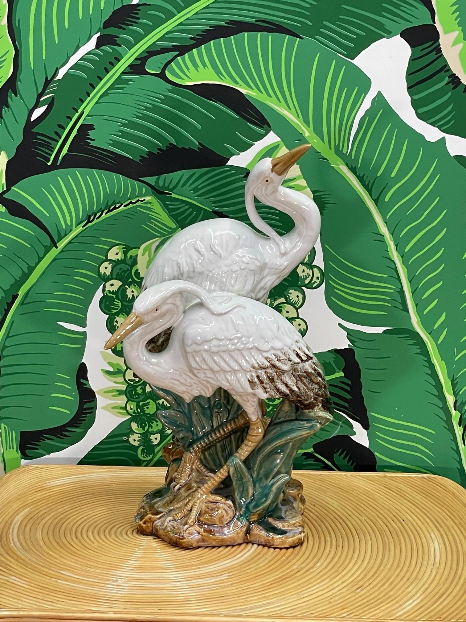 Ceramic pair of egrets features a high gloss glaze and brightly colored detailing. Stands 18