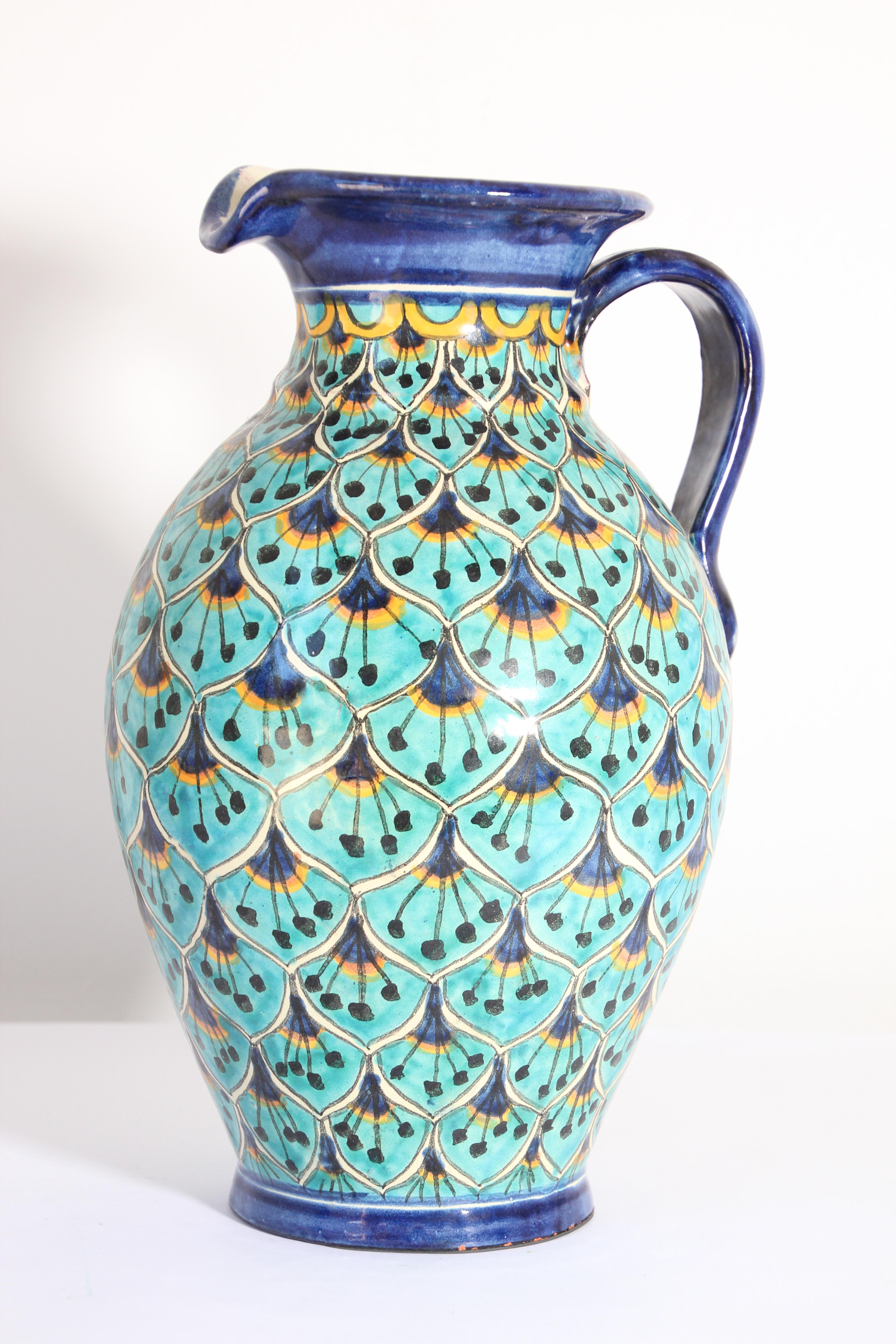 Glazed polychrome ceramic Talavera pitcher or flower vase with Moorish peacock blue design.
Hand painted Talavera ceramic pitcher, handcrafted by skilled artisans in Spain in the Granada Moorish style.
Unique vintage piece of traditional Moorish