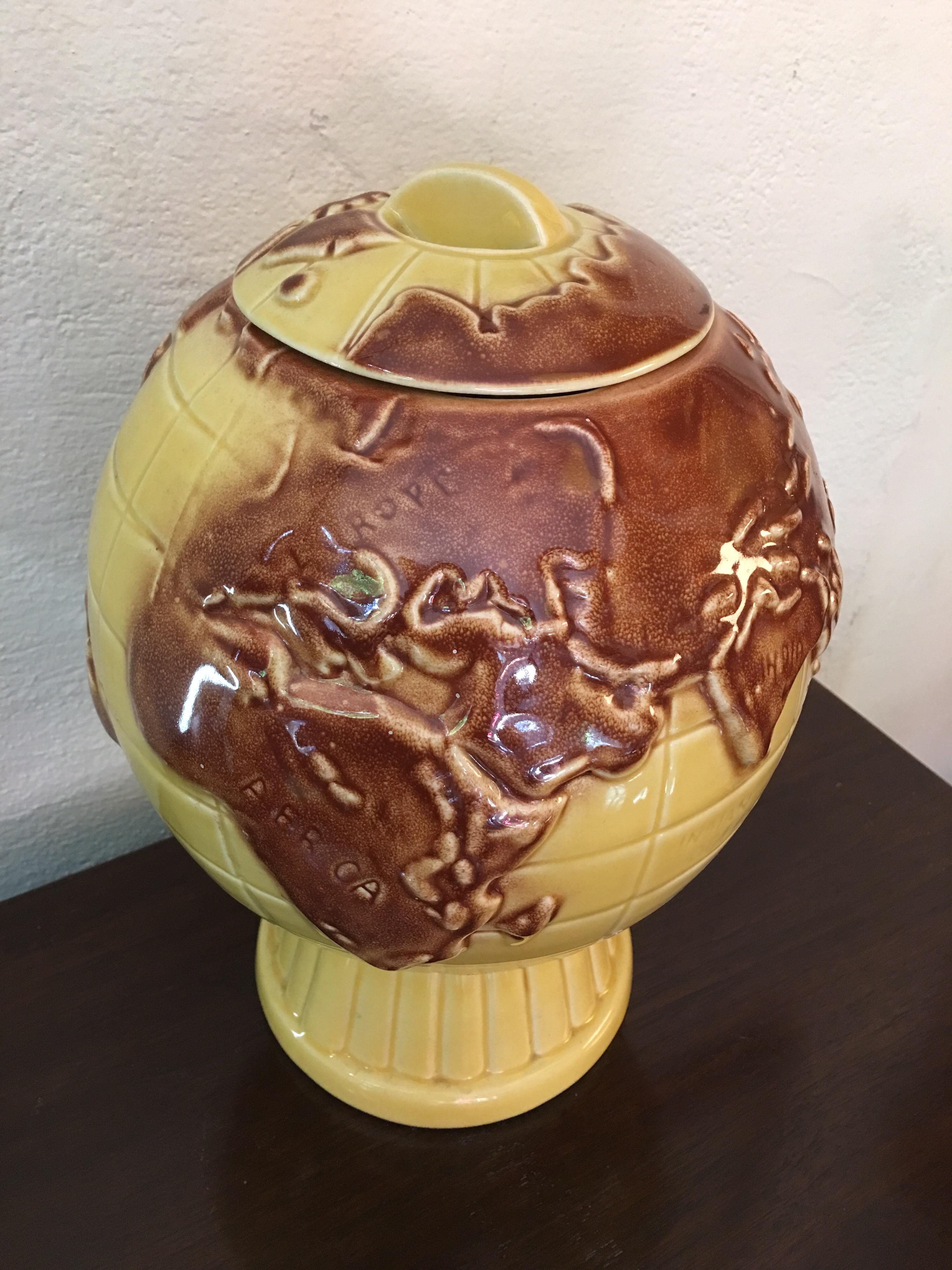 Ceramic globe cookie jar in shades of yellow and brown. Whimsical, clever cookie jar in great shape. No maker's mark to bottom but I would guess a late 1960s-early 1970s design.