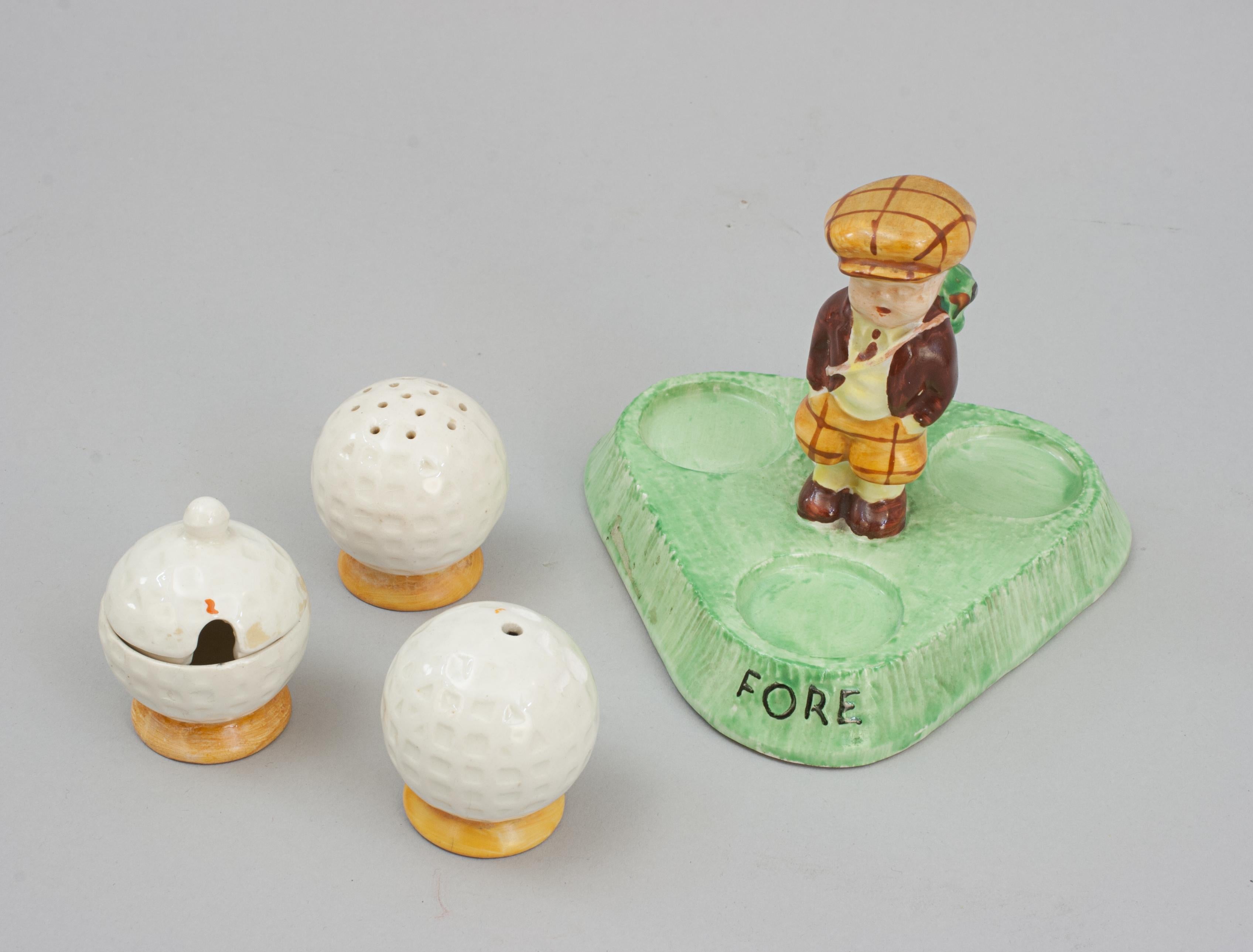 Ceramic Novelty Golf Condiment Set.
Fielding's Crown Devon golf cruet set, the carry handle in the shape of a golfer in plus fours and cap carrying a bag of golf clubs over his shoulder. The salt, pepper and mustard pots are in the shape of dimple