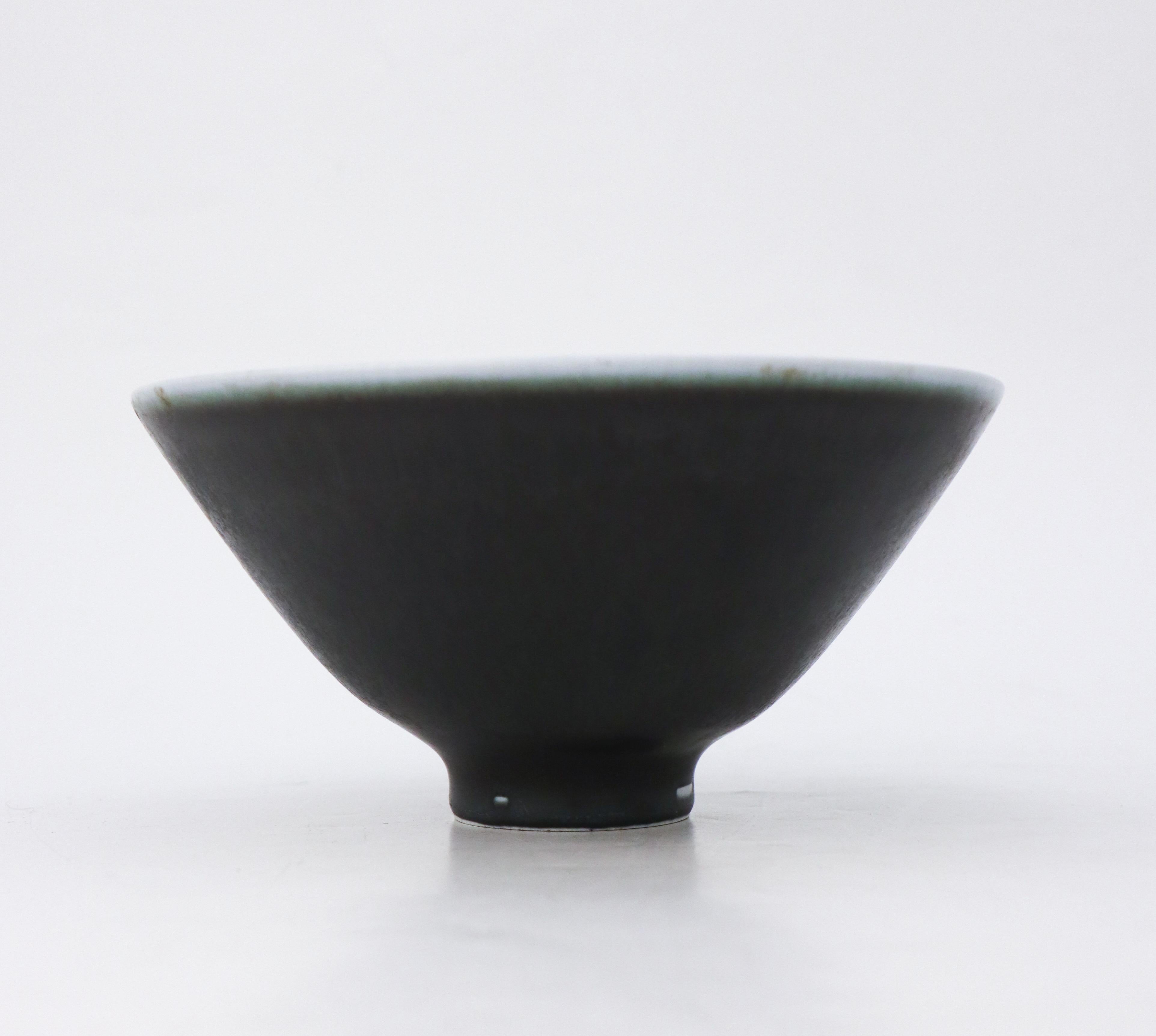 Precioso cuenco negro diseñado por Carl-Harry Stålhane en Rörstrand. Mide 18,5 cm de diámetro en la parte superior y 9,5 cm de altura. Está en excelente estado, excepto por unas pequeñas marcas en el esmalte cerca de la base, por lo que está marcado