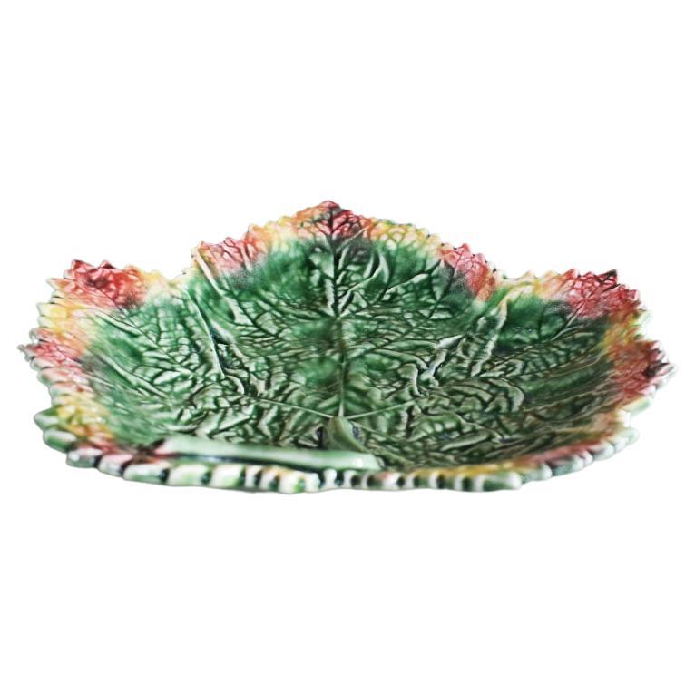 A pretty green, orange, and red majolica leaf plate by Bordallo Pinheiro. This plate will be a fabulous addition to your next dinner party. Use it to serve rolls or appetizers and pair it with your favorite Dodie Thayer inspired lettuce ware