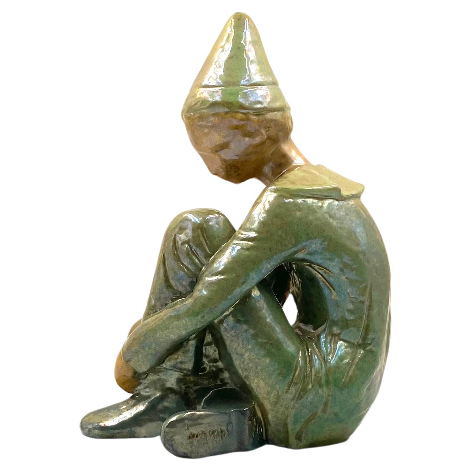 Ceramic green figure of Sitting boy, Giordano Tronconi, Faenza Italy, 1950s For Sale