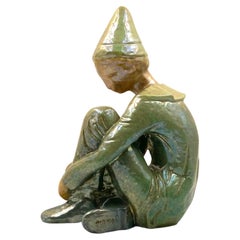 Ceramic green figure of Sitting boy, Giordano Tronconi, Faenza Italy, 1950s