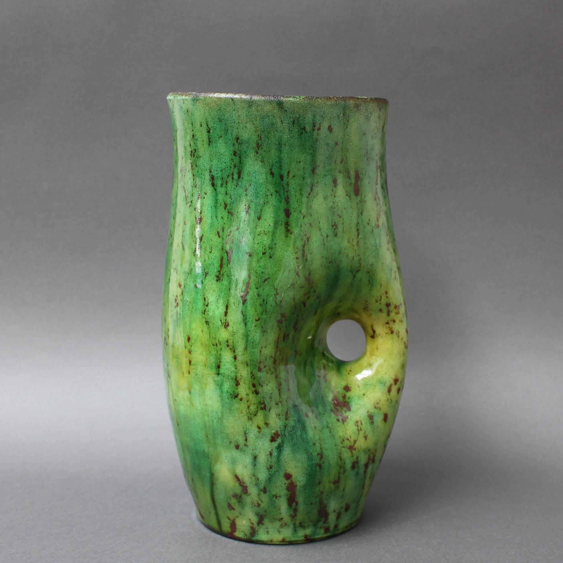 Ceramic vase by Accolay, circa 1960s. A deep jade green combines with a darker flattened drip effect on a curvaceous vase with integrated handle. Beautiful on the eyes and touch - sensuous and tactile. Maker's mark on base - signed 'Accolay' and 'A