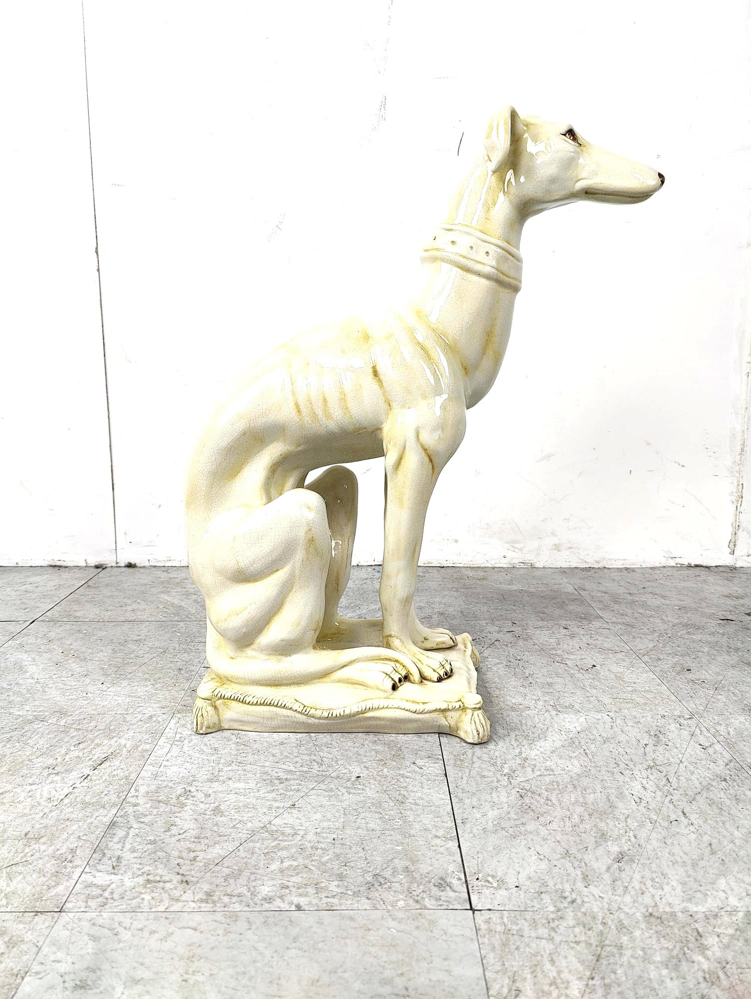Gorgeous and naturally sculpted sculpture of a sitting greyhoudn made from cracklé ceramic and made in italy.

Beautiful and elegant posture sitting on a cushion.

Good condition

1960s - Italy

Height: 67cm
With: 26cm
Depth: 45cm

Ref.: 249552