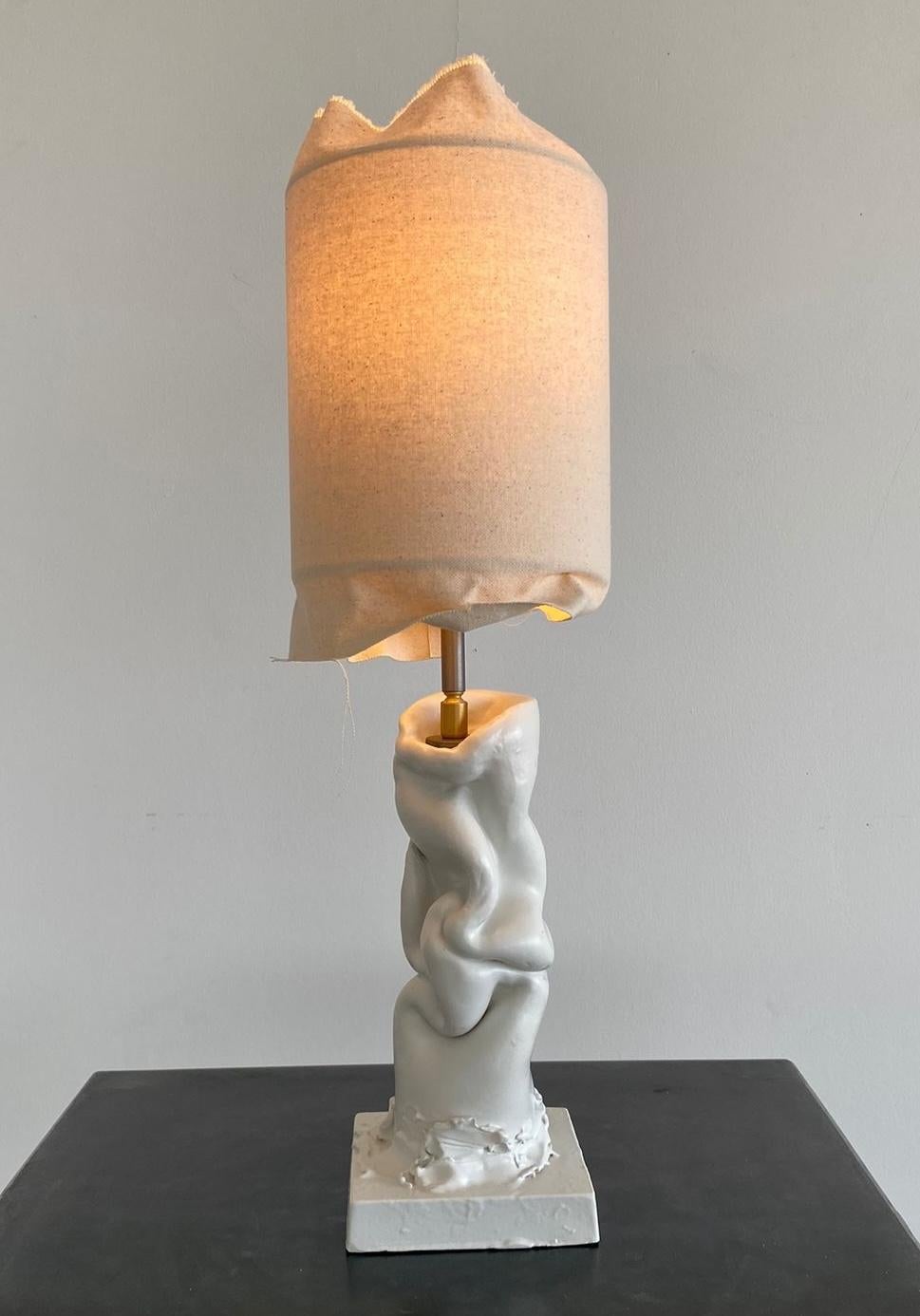 The 'Asiago 01' is a handmade ceramic lamp and part of a project entitled Break the Mold by artist Jenna Basso Pietrobon. 

Adjustable canvas lampshade. Metal and brass details. Lamp is signed on the back or bottom. 

Other voltage/ wiring upon