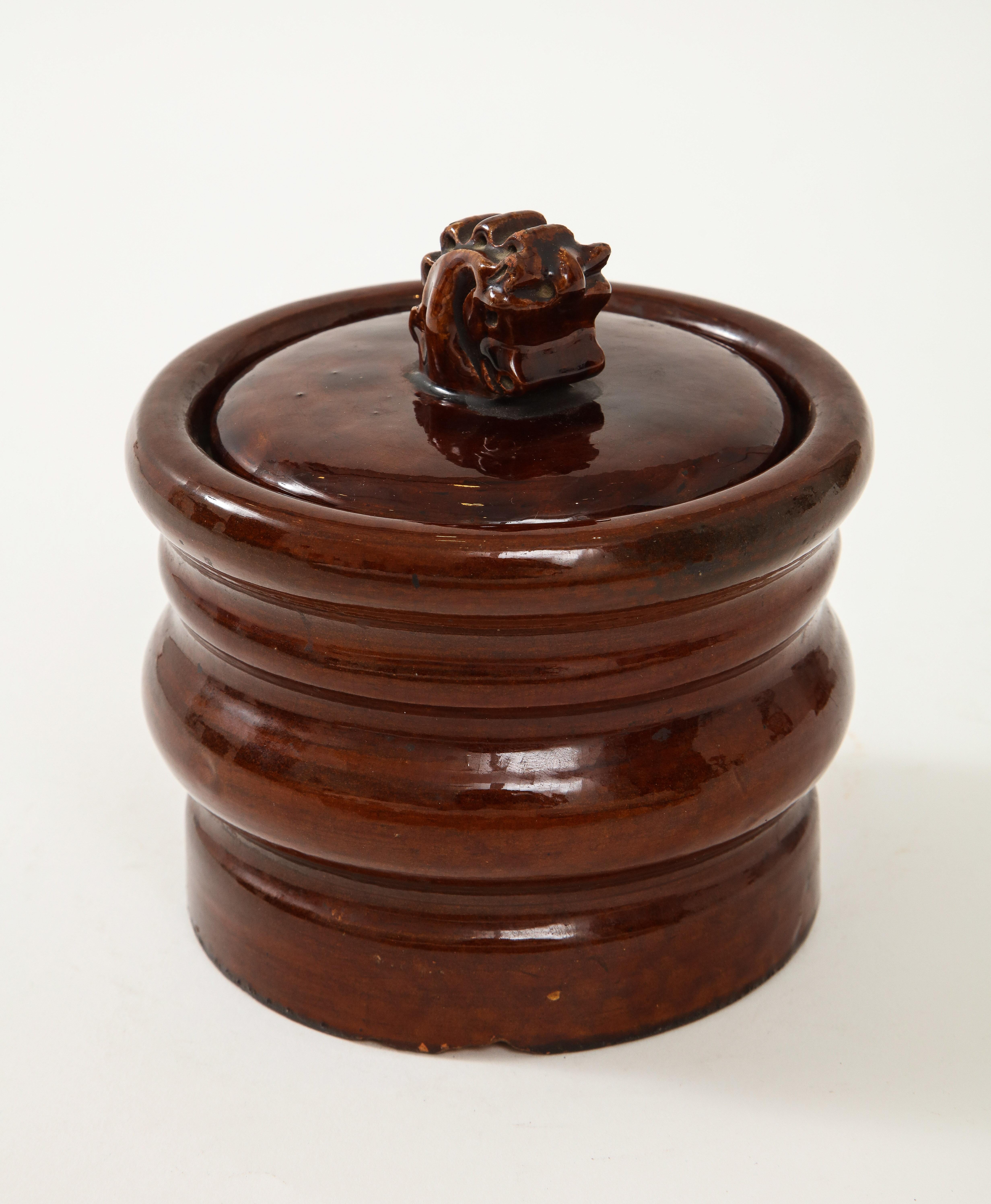 Brown vintage ceramic Hermès tobacco jar, France, c. 1950s. 

This stunning object consists of a sculptural base, lidded top, and horse bust handle. 

 