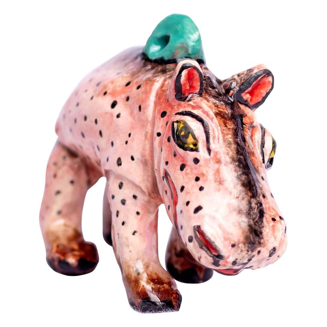 This charming ceramic hippopotamus ornament, handcrafted in South Africa by Zimele Ceramics, is a delightful representation of one of Africa’s most powerful and iconic animals. Measuring 2 inches high, 3 inches in length, and 1 inch wide, the piece
