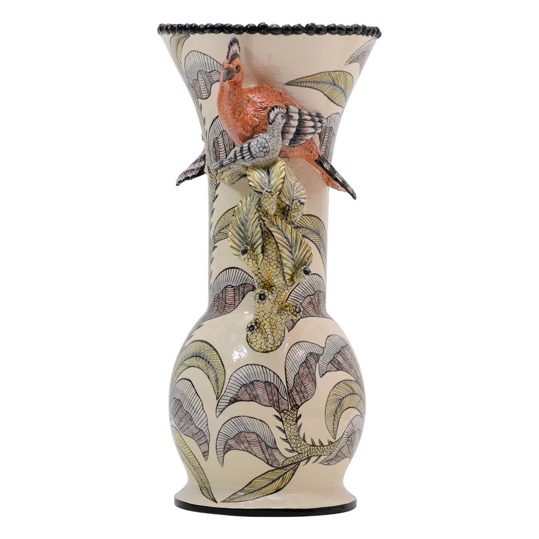 The ceramic Hoopoe Vase, a stunning creation by Sbusiso Ndaba and hand-painted by Zinhle Nene at Love Art Ceramic in South Africa, intertwines nature and artistry. Standing at 14 inches high, 6 inches in length, and 6 inches in width, it showcases