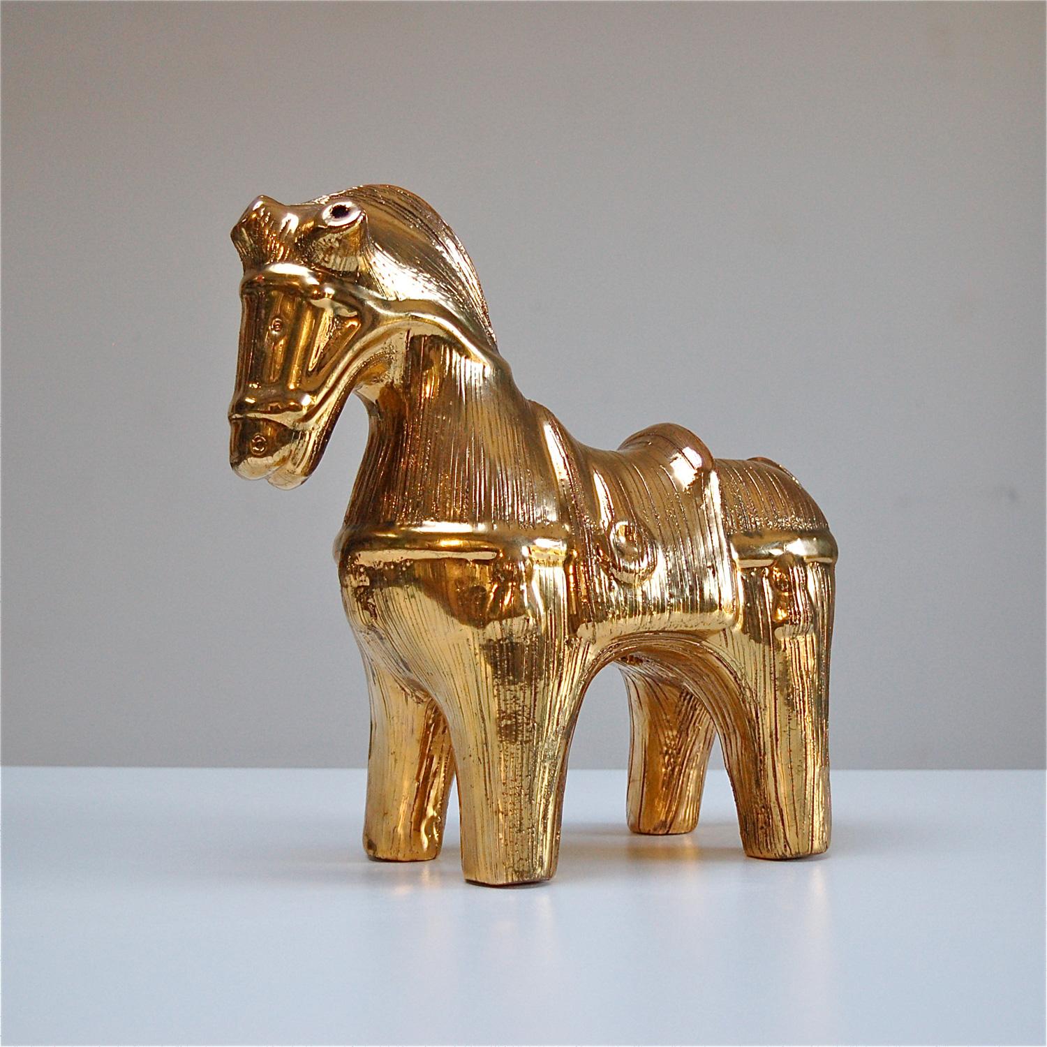 Bitossi ceramic horse sculpture or Cavallo designed by Aldo Londi. The gold enamel edition was produced approx between 1968 and 1973. The shimmering effect is achieved by mixing 24-karat gold leaf to the glaze. The metallic luster has had a third