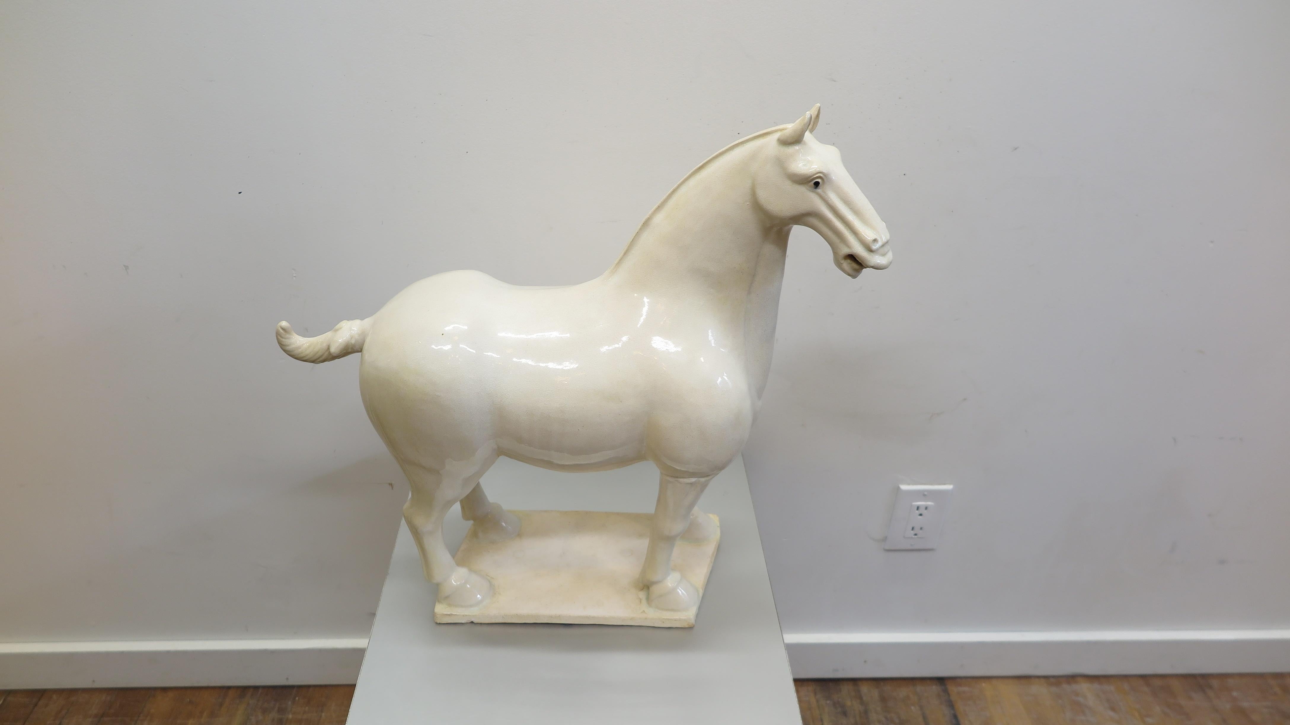 Ceramic horse sculpture in the style of tang dynasty pottery. Late 20th century Chinese ceramic horse sculpture. Off white crackle glaze over pottery. Very nice large scale piece. We have a similar black horse that complements this white horse. See