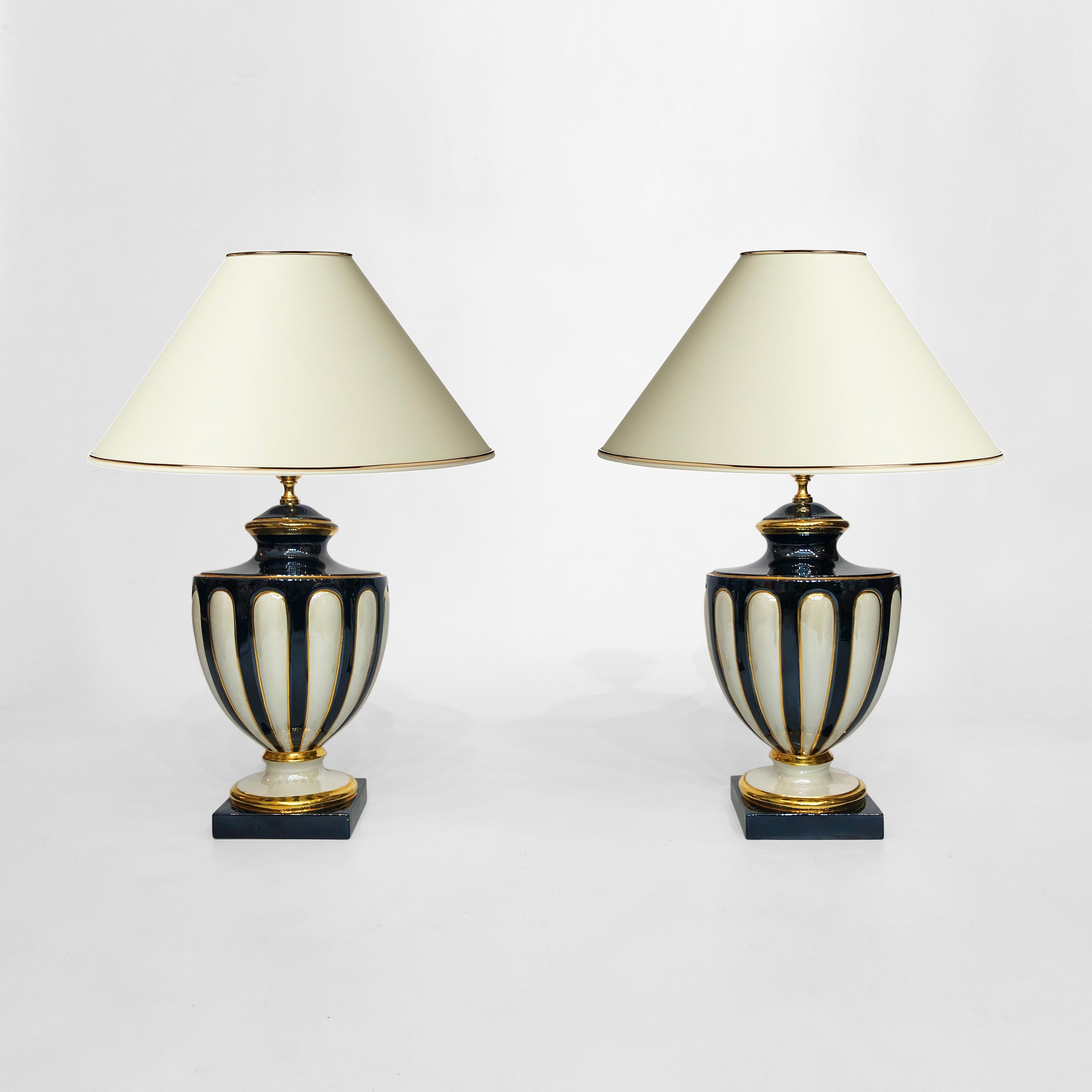 A bold pair of ceramic table lamps from Italy, very much in a neoclassical style and designed towards the end of the 1970s. Taking the form of a trophy urn, these lamps contain many of the usual neoclassical tropes: fluting; an organic, curved form;
