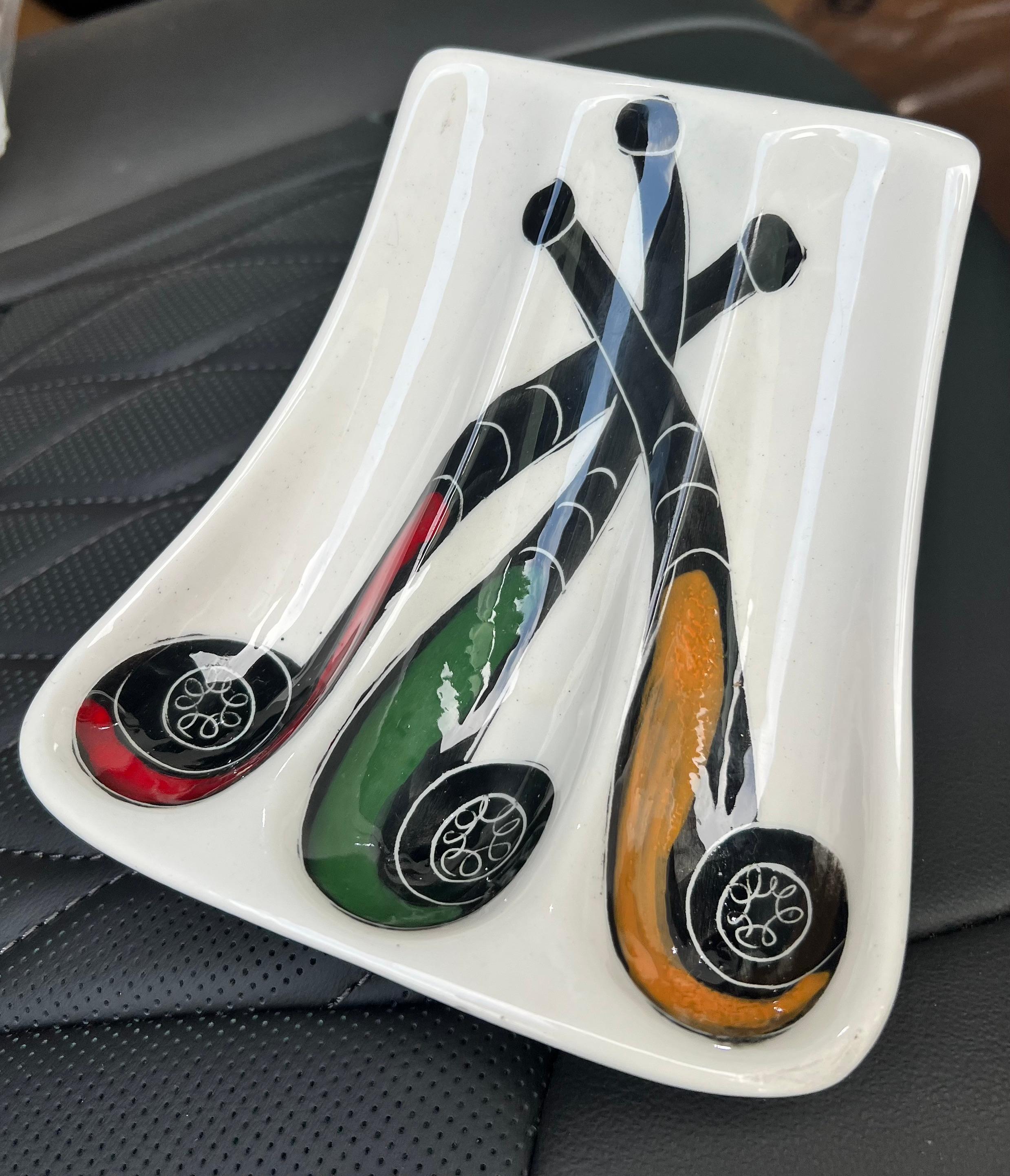 A wonderfully decorative piece - designed to hold pipes, but works well as a stand alone.  

Hand painted in Italy, it is reminiscent of Fornasetti - whimsically painted pipes in brilliant colors.  
No chips or cracks, in very good condition, with a