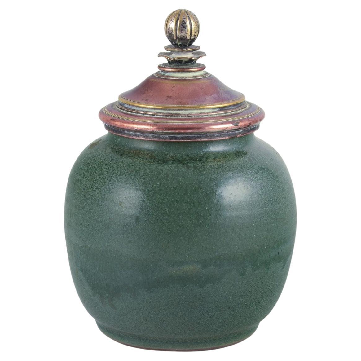 Ceramic jar glazed in green hues. With a brass and bronze lid. For Sale