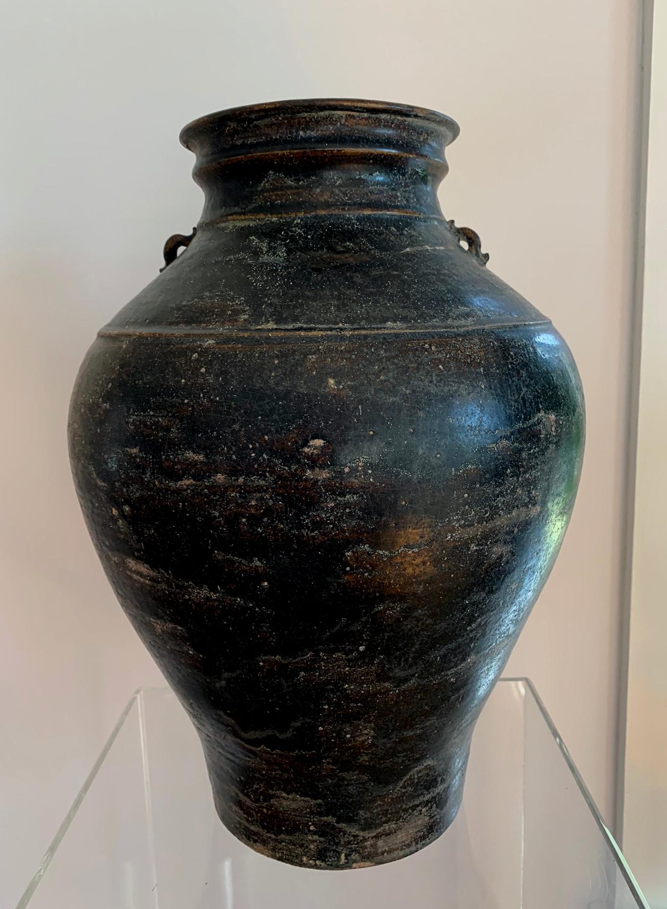 On offer is a stoneware ceramic jar with black iron glaze from Khmer Kingdom (now Cambodia) dated to Angkor period circa 12th century. The vase is constructed in a solid but elegant form with a slightly terraced neck and mouth. Two molded and