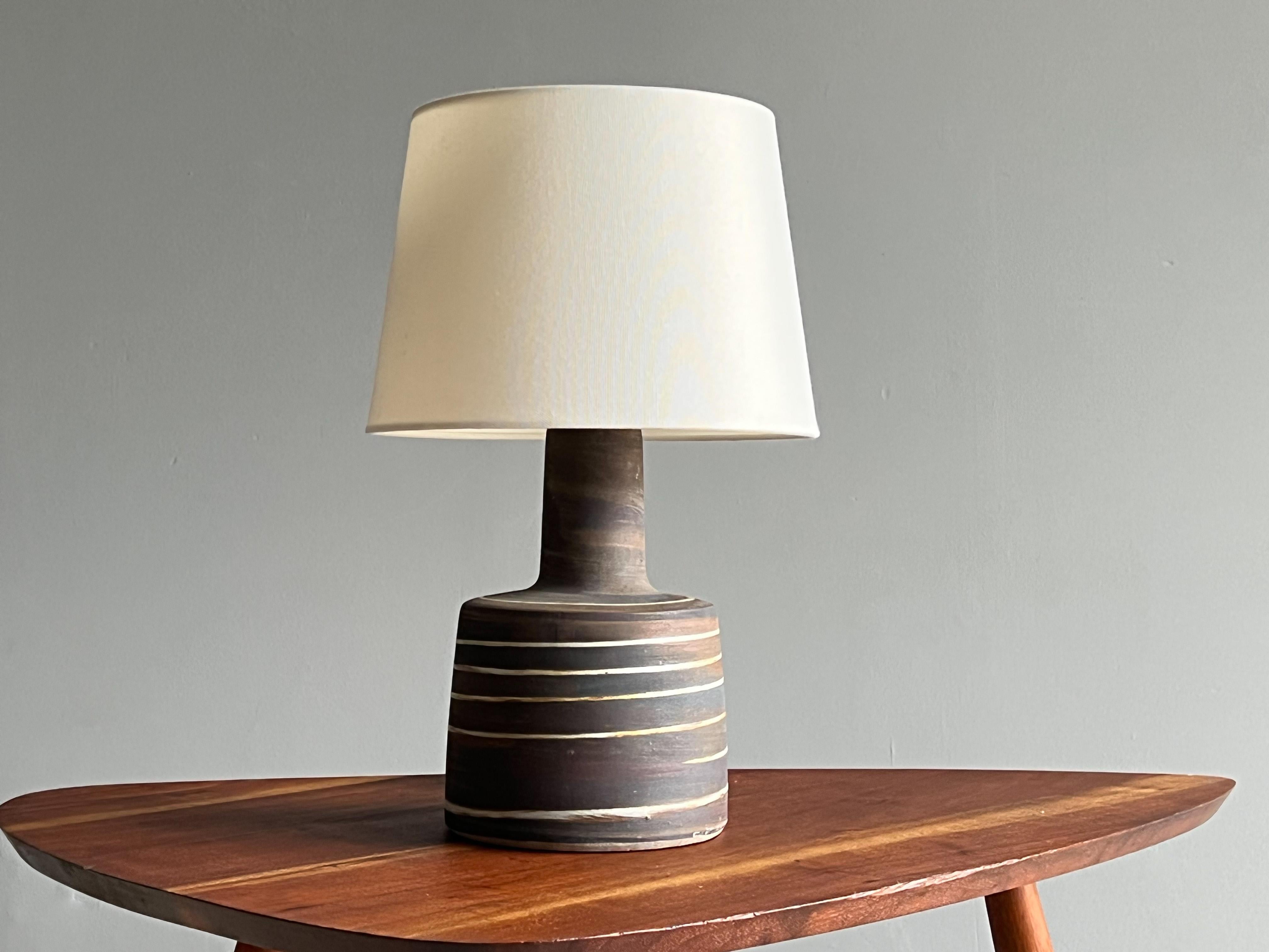 Pottery table lamp designed by award winning husband and wife duo Jane and Gordon Martz for Marshall studios. Circa 1960s. 

 Ceramic body with muted purples, light browns, flat black and a white spiraling glaze. Lovely example of a handmade lamp.
