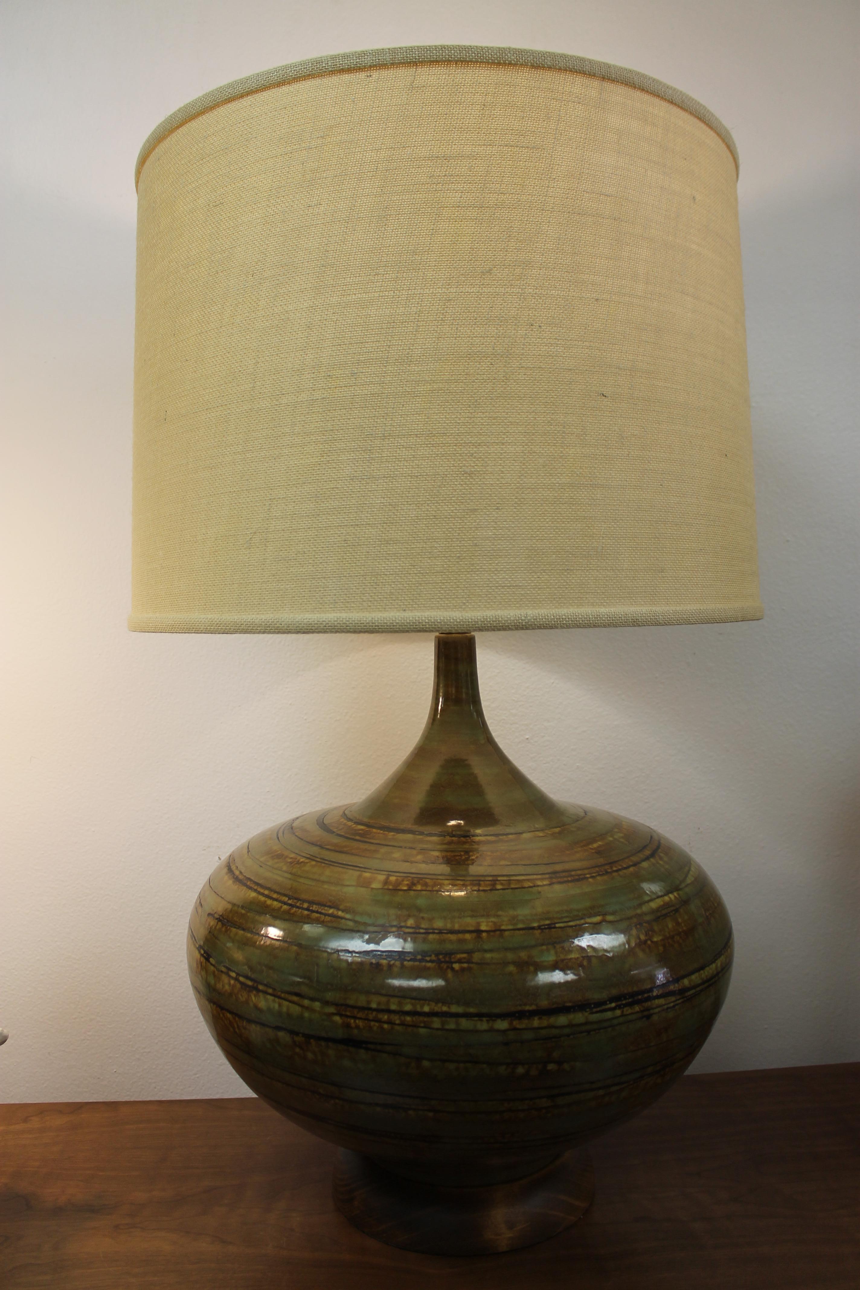 Ceramic lamp consisting of brown, black and green swirls throughout. Lamp is 20