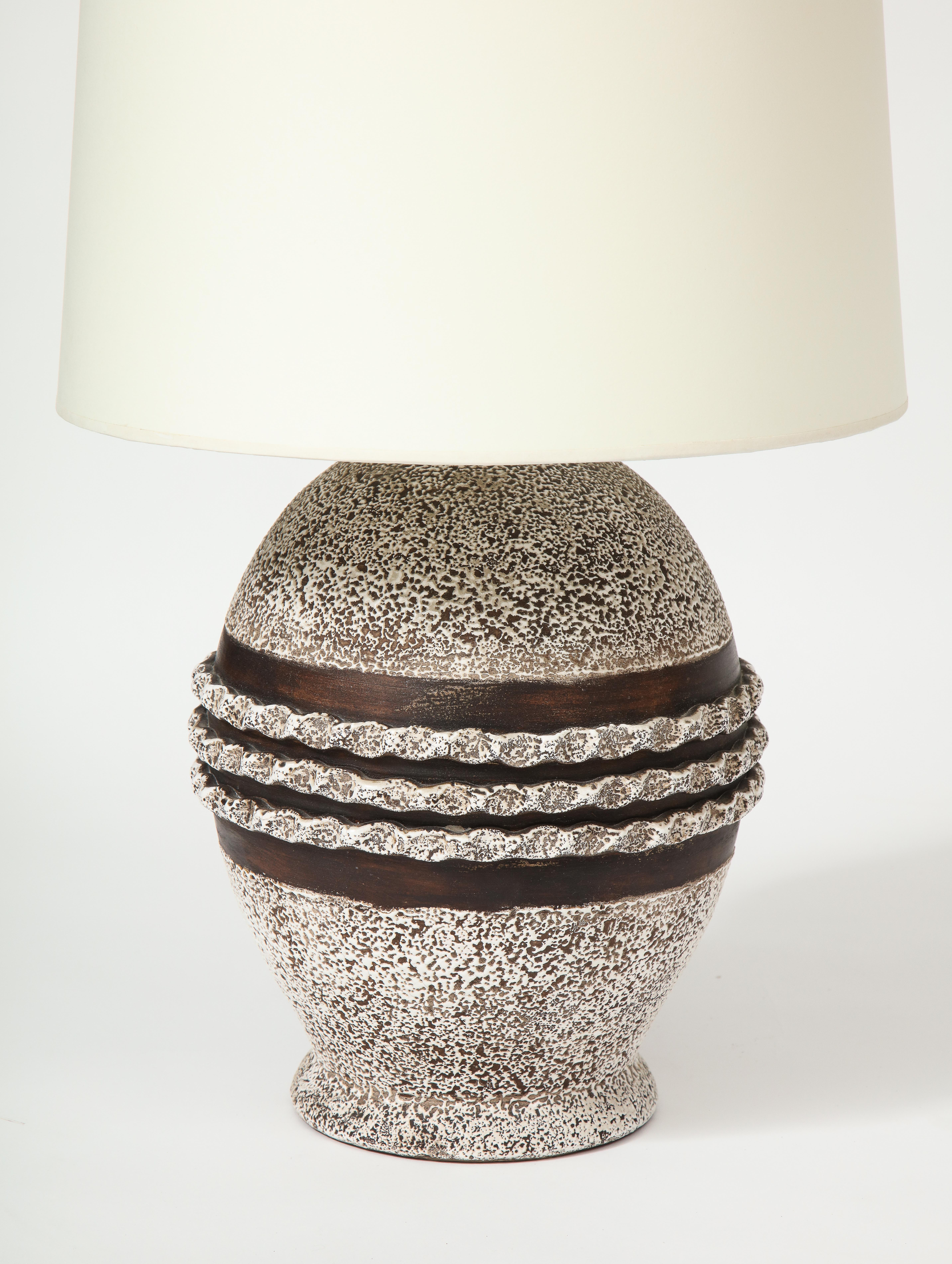 Ceramic lamp in the style of Jean Besnard, France, c. 1930-40
Vermicule decoration, Custom-made parchment paper shade
Ceramic, bronze hardware
Measures: Height 24, diameter 9 in.