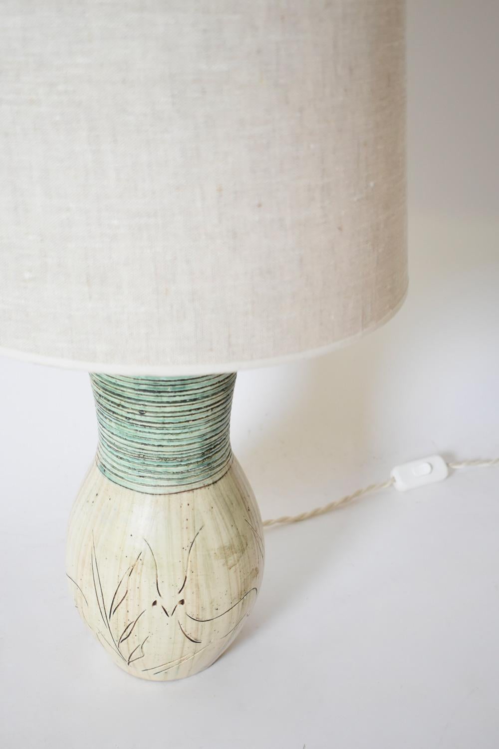 Incised and glazed ceramic lamp, baluster-shaped, decorated with a spring bock pattern, the neck ridged. France, 1950s.