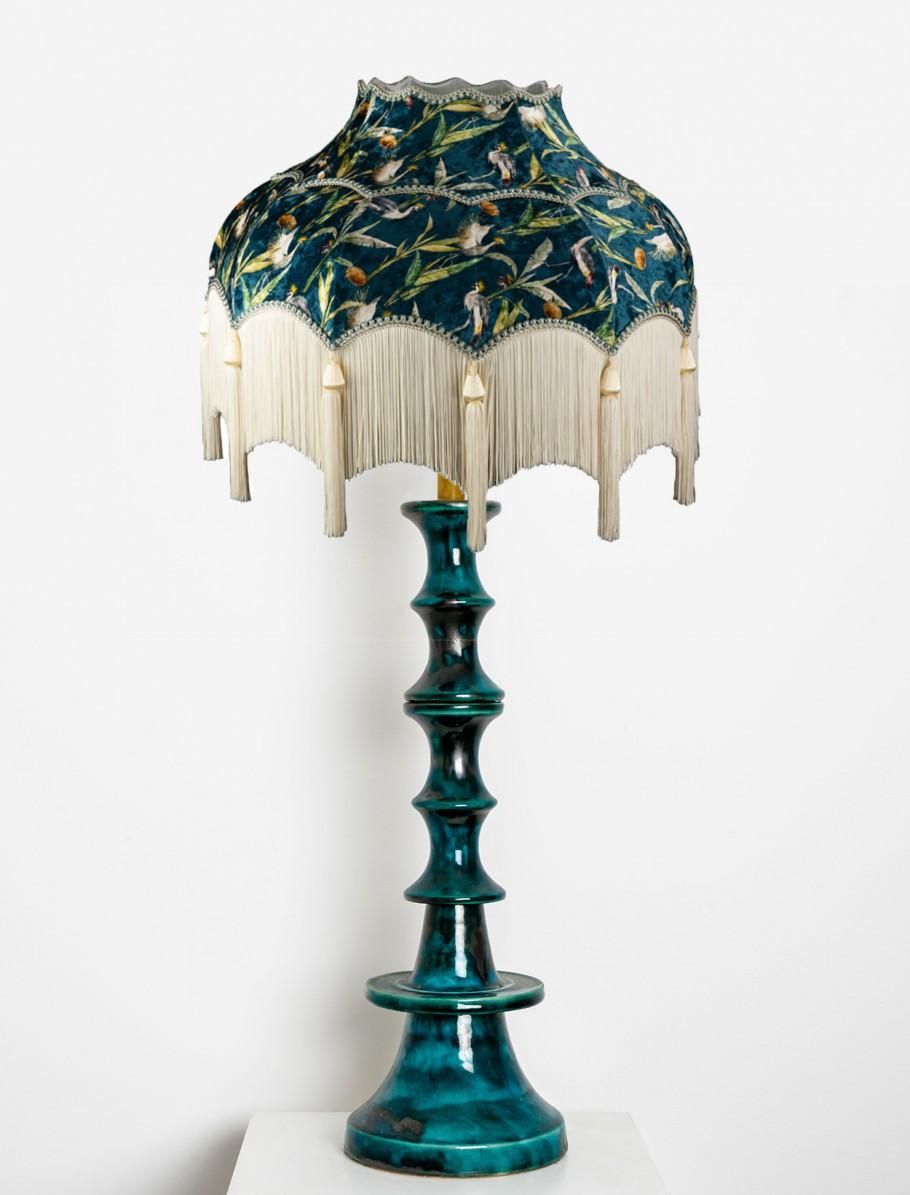 Beautiful turquoise ceramic floor lamp with wonderful handmade fringed lampshade. The ceramic base is made by Kaiser, Europe, Germany in the 1960s. Beautiful sculptural piece handmade ceramic in rich glazed turquoise color.
The lamp features a
