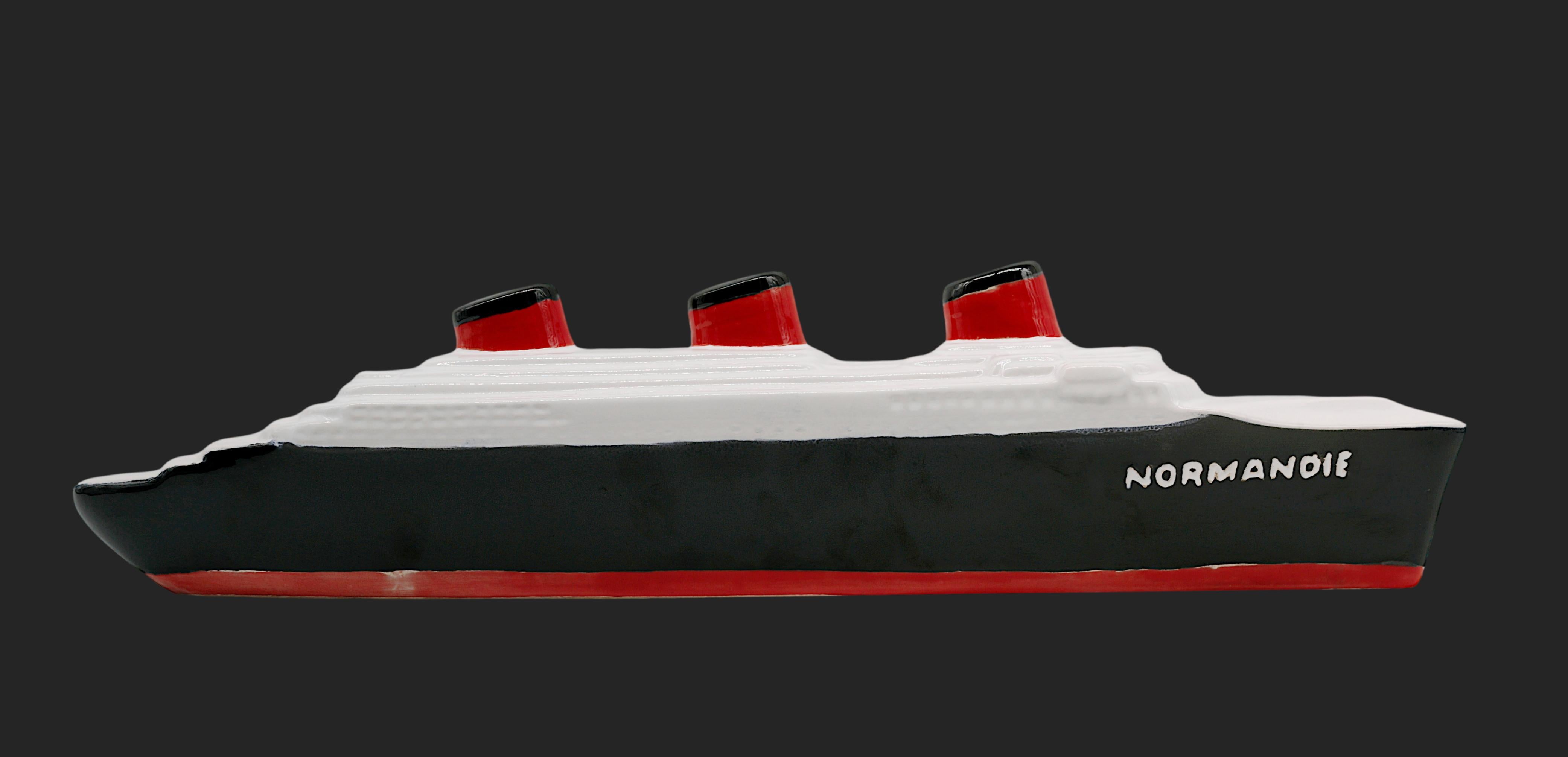 This ceramic representation of the SS Normandie, created by the Compagnie Générale Transatlantique in the 20th century, beautifully captures the iconic French ocean liner. The piece is marked 