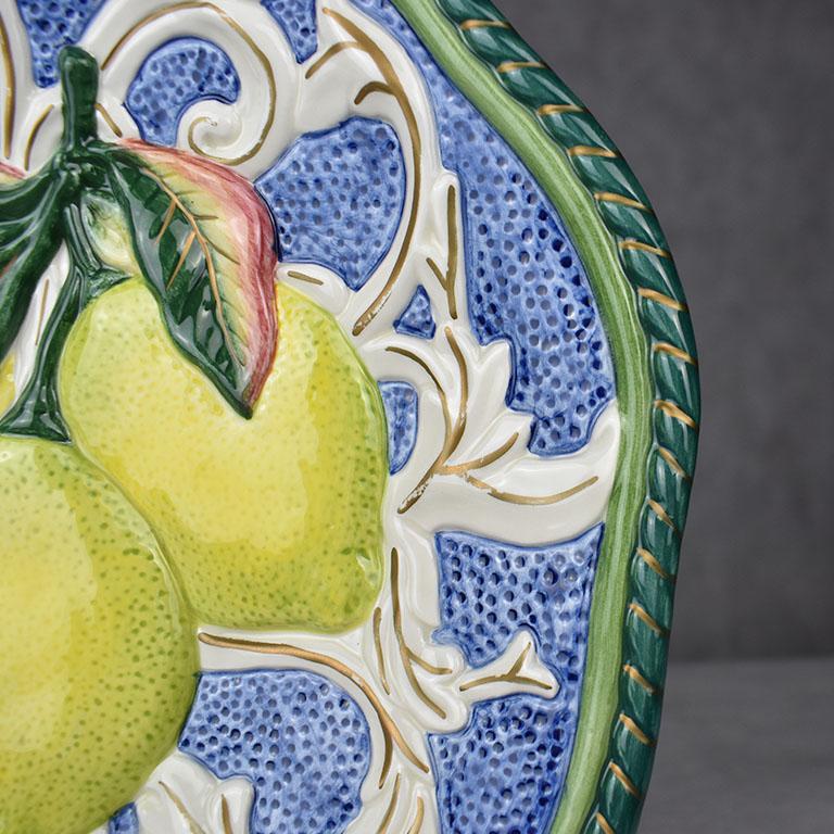 Octagonal Majolica lemon motif plate in green, yellow, blue and red. This piece by Fitz and Floyd would be a fabulous addition to any plate collection. Either for a place setting or for use as a wall hanging. However this beauty is used, it is sure