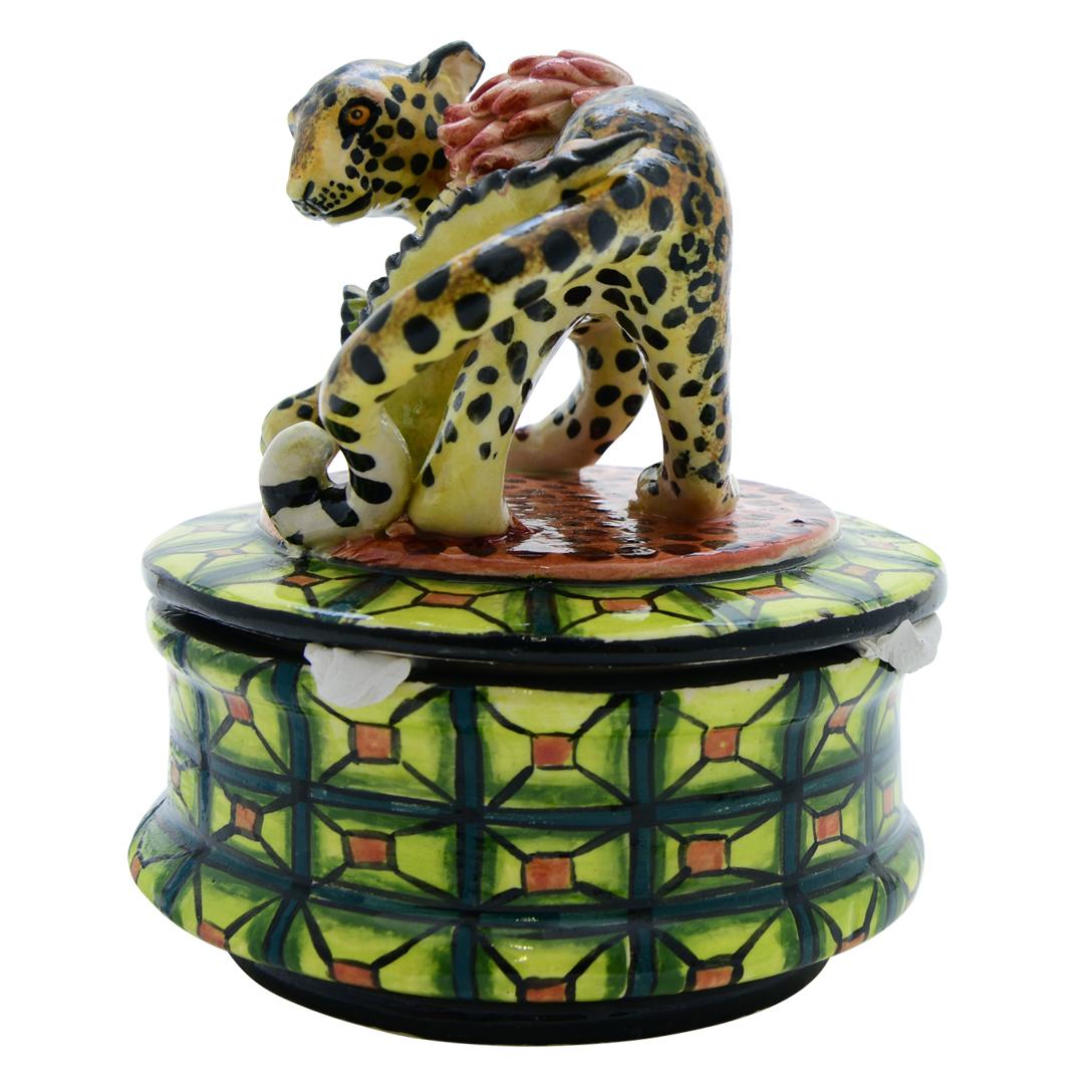 Crafted by Lefu and Sindy at Senzo Duma Ceramics in South Africa, this ceramic Leopard jewelry box stands 4 inches high, 5 inches long, and 4 inches wide. Lefu's sculpting expertise brings out the leopard's sleek form, embodying its significance in