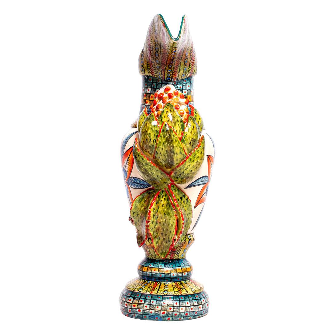 The ceramic Leopard jug from Wiseman Ceramics embodies the essence of African wildlife and culture. Hand-sculpted by George and Thabo, and hand-painted by Riya, this unique piece stands 14 inches high, 10 inches long, and 4 inches wide. Its design