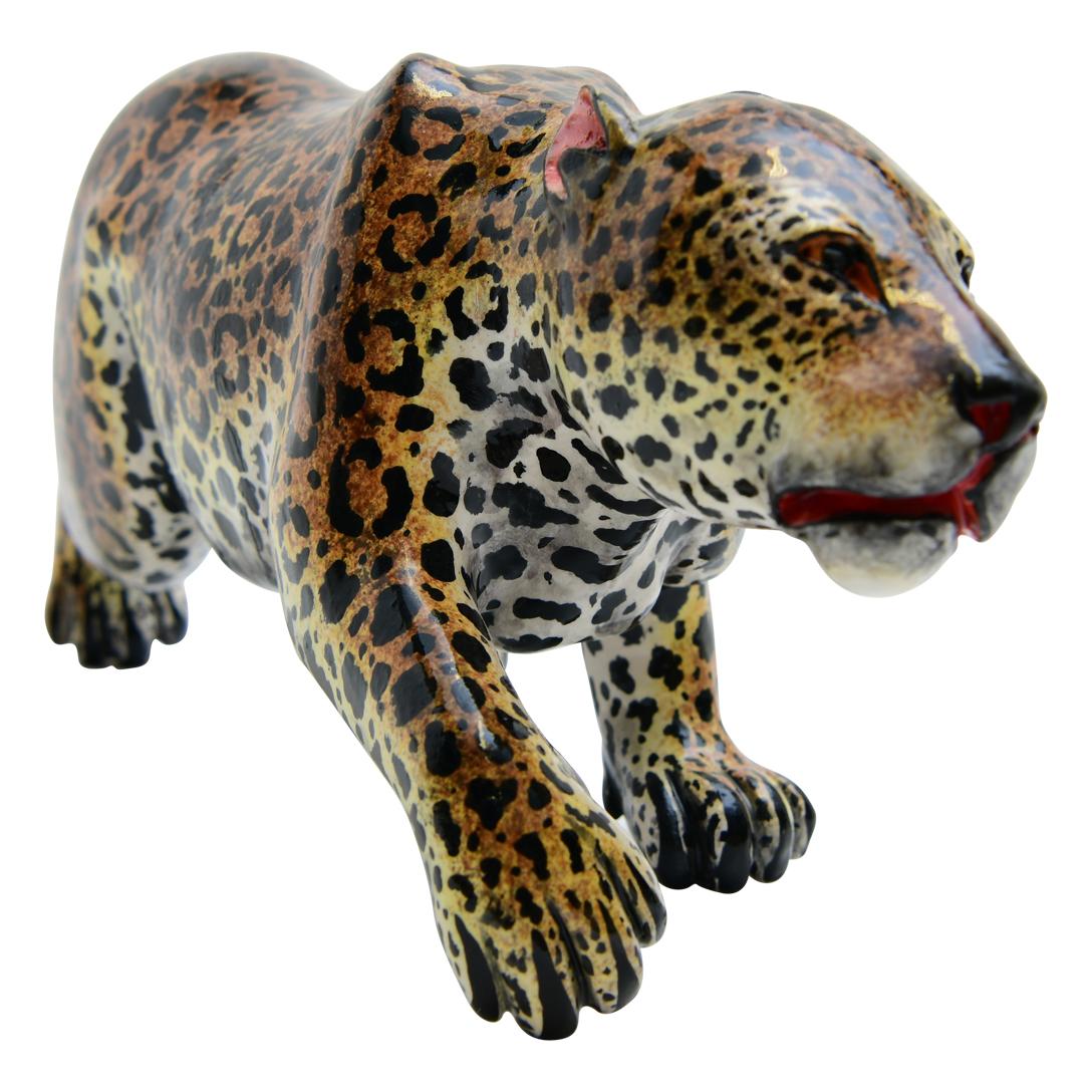 The ceramic Leopard sculpture from Imvelo Natural Art in South Africa is a stunning piece, standing tall in a poised pose that exudes strength and grace. Hand-sculpted by Bernard and meticulously hand-painted by artisan Sbusiso, every detail