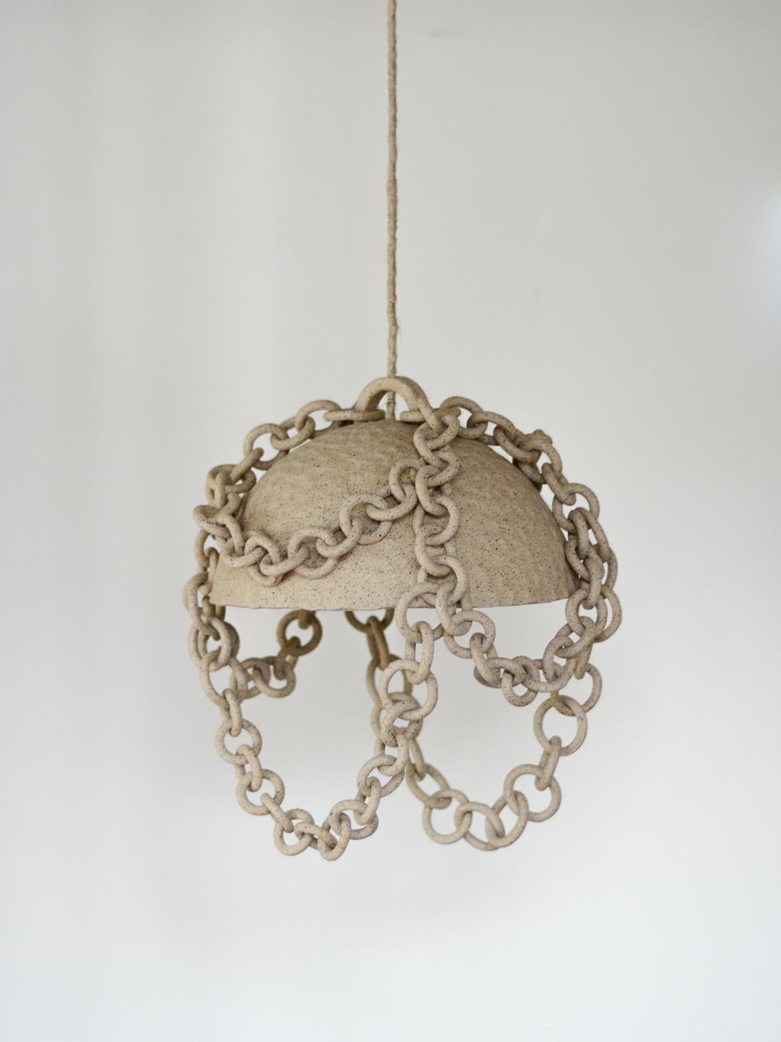 THIS CHANDELIER IN CLAY #60 IS READY TO SHIP FOR OTHER COLORS EXPECT 5-6 WEEKS FOR ORDER TO SHIP
 
The ceramic chandelier  is a captivating piece of art that seamlessly blends earthy, organic modern aesthetics with a nomadic, bohemian or beachside