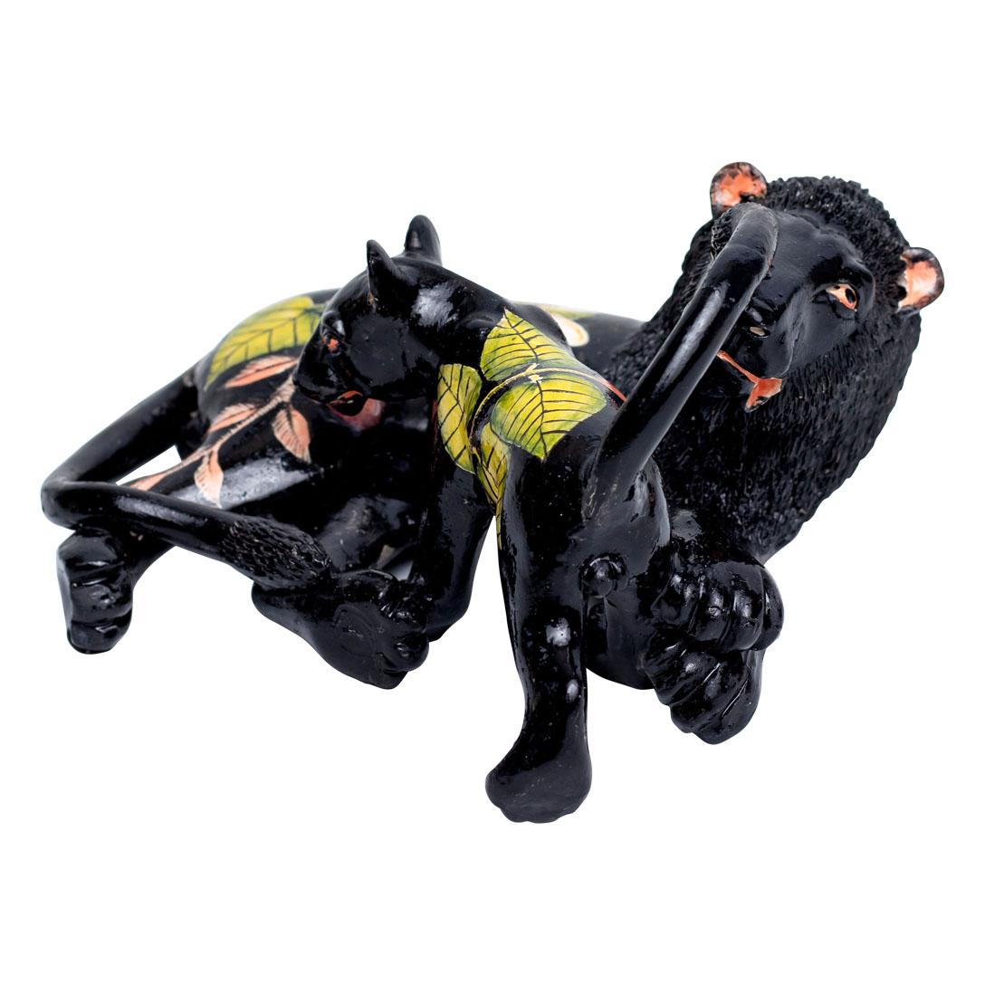 Hand-sculpted by Thabo and meticulously hand-painted by Lindo at Wiseman Ceramics in South Africa, this ceramic Lion sculpture measures 5 inches high, 9 inches in length, and 9 inches wide. Designed by Wiseman, the sculpture embodies the essence of