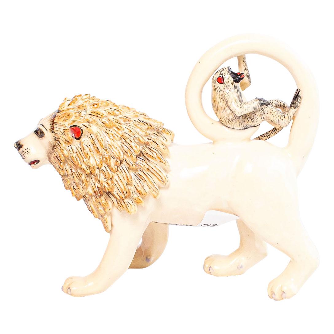 The White Lion and Monkey ceramic sculpture, produced by Zimele Ceramics in South Africa, is a remarkable piece of art from the African Circus collection. Measuring 6 cm high, this hand-painted creation by Sello and hand-sculpted by Sneh, features a