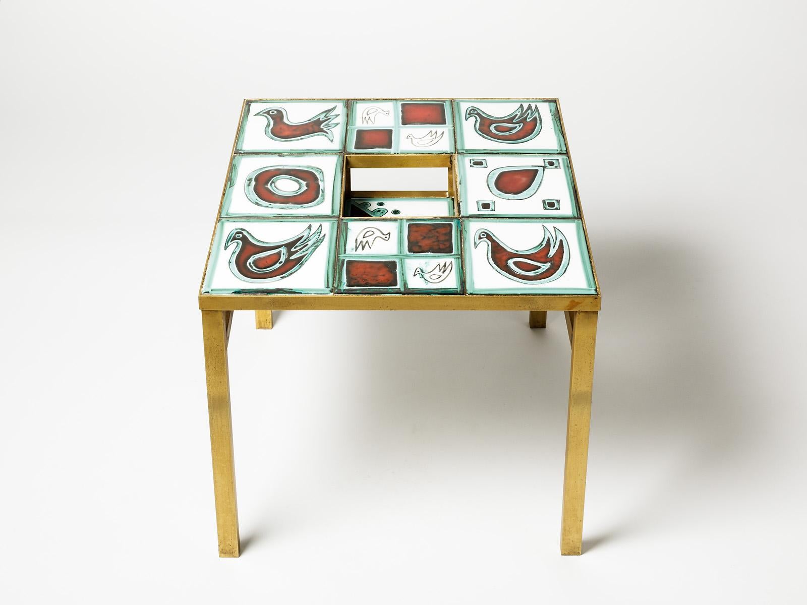 Elegant ceramic low coffee table, circa 1970.

French production attributed to Poet Laval in south of France.

Really beautiful golden brass feet.

Dimensions: 40 x 45 x 45cm.