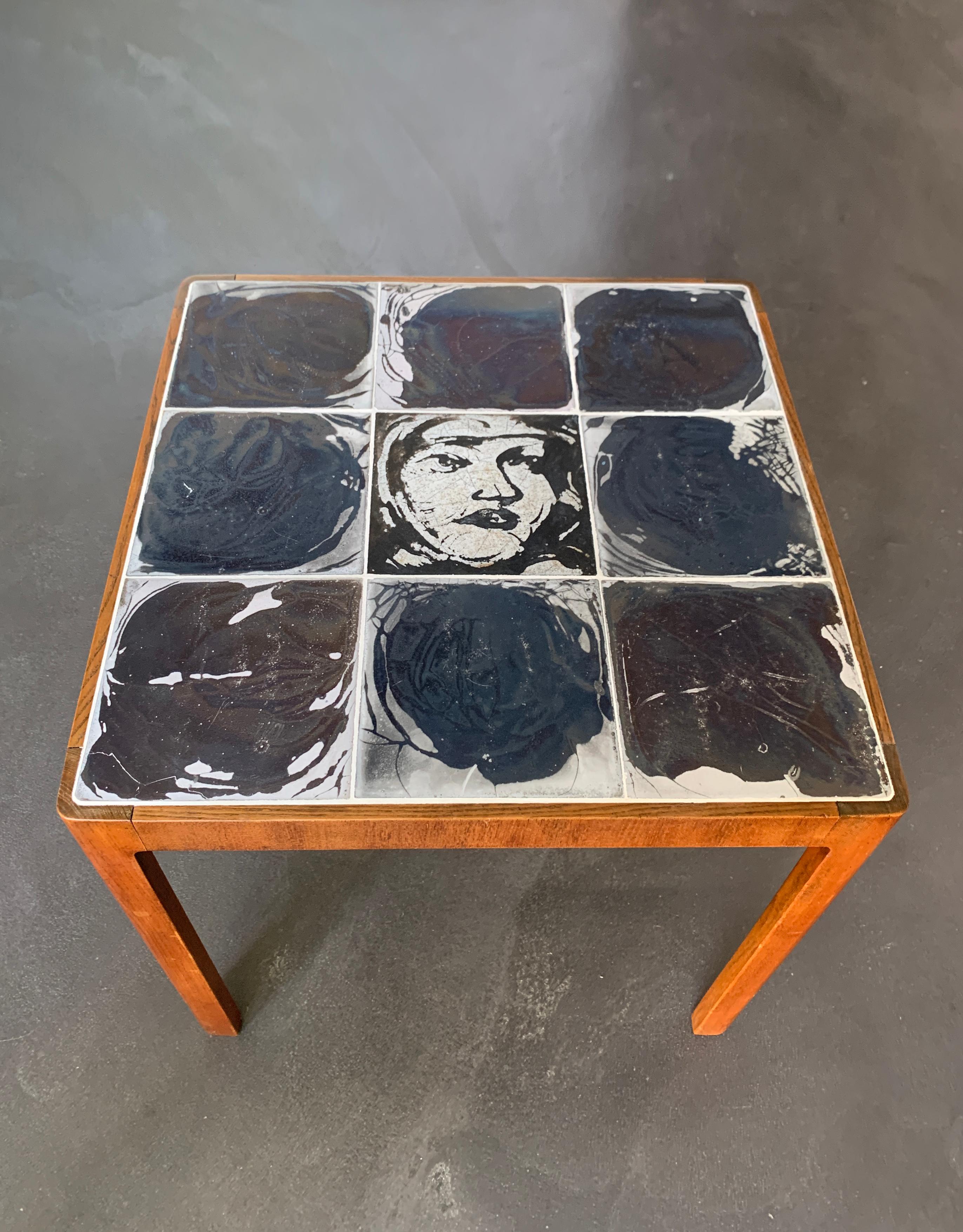 Scandinavian Mid-Century side table. Made of Ceramic tiles and Mahogany wood. 
Tiles made by Herman A Kähler Ceramic, located in the town of Naestved on the island of Zealand (southern Denmark). Kähler ceramics has been founded in 1839 and is still